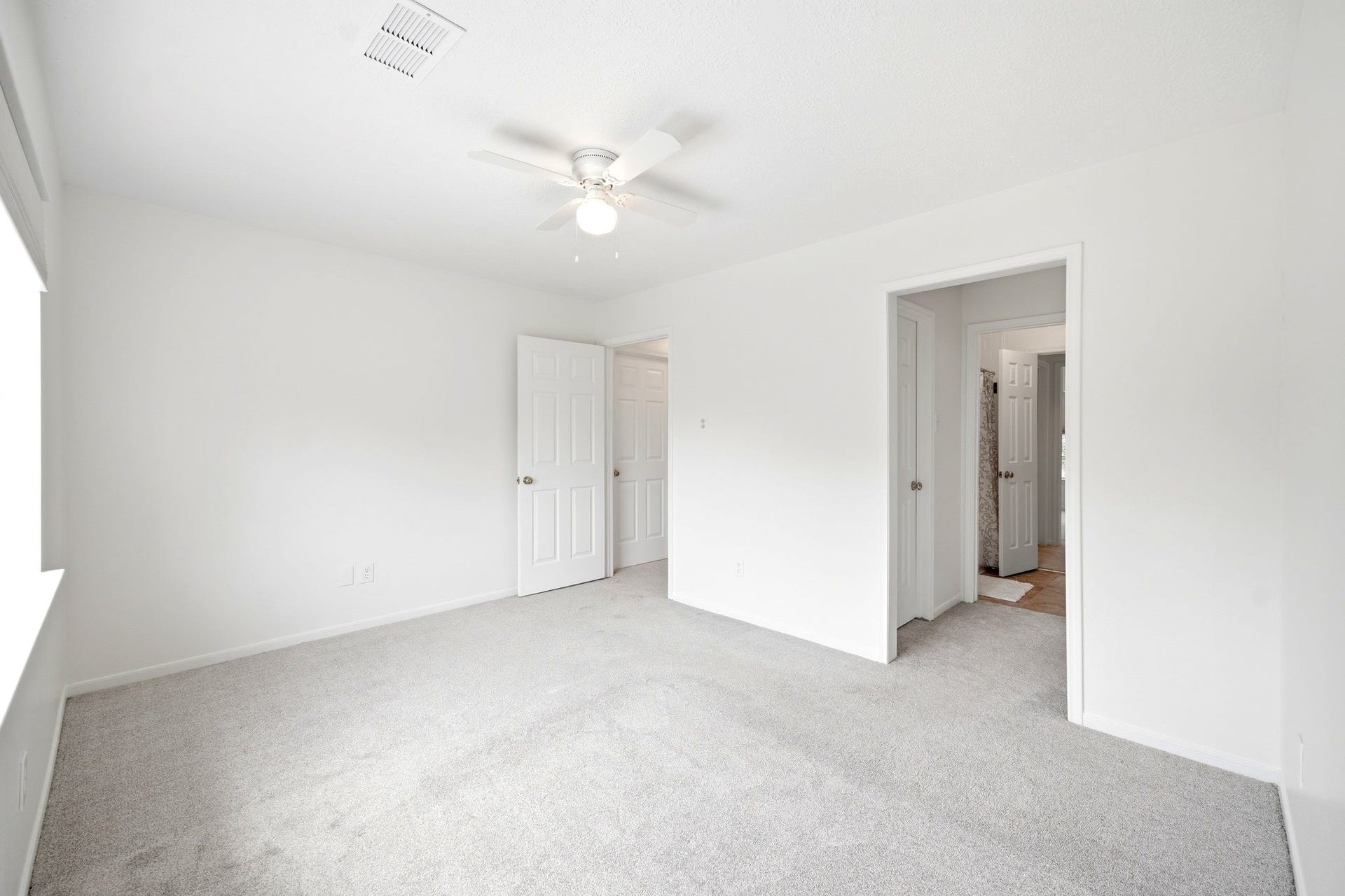 2216 Fairwater Park Drive, League City, TX 77573 Bright and inviting, the third bedroom offers a blank canvas with plush carpeting and ample natural light, ready for your personal touch.