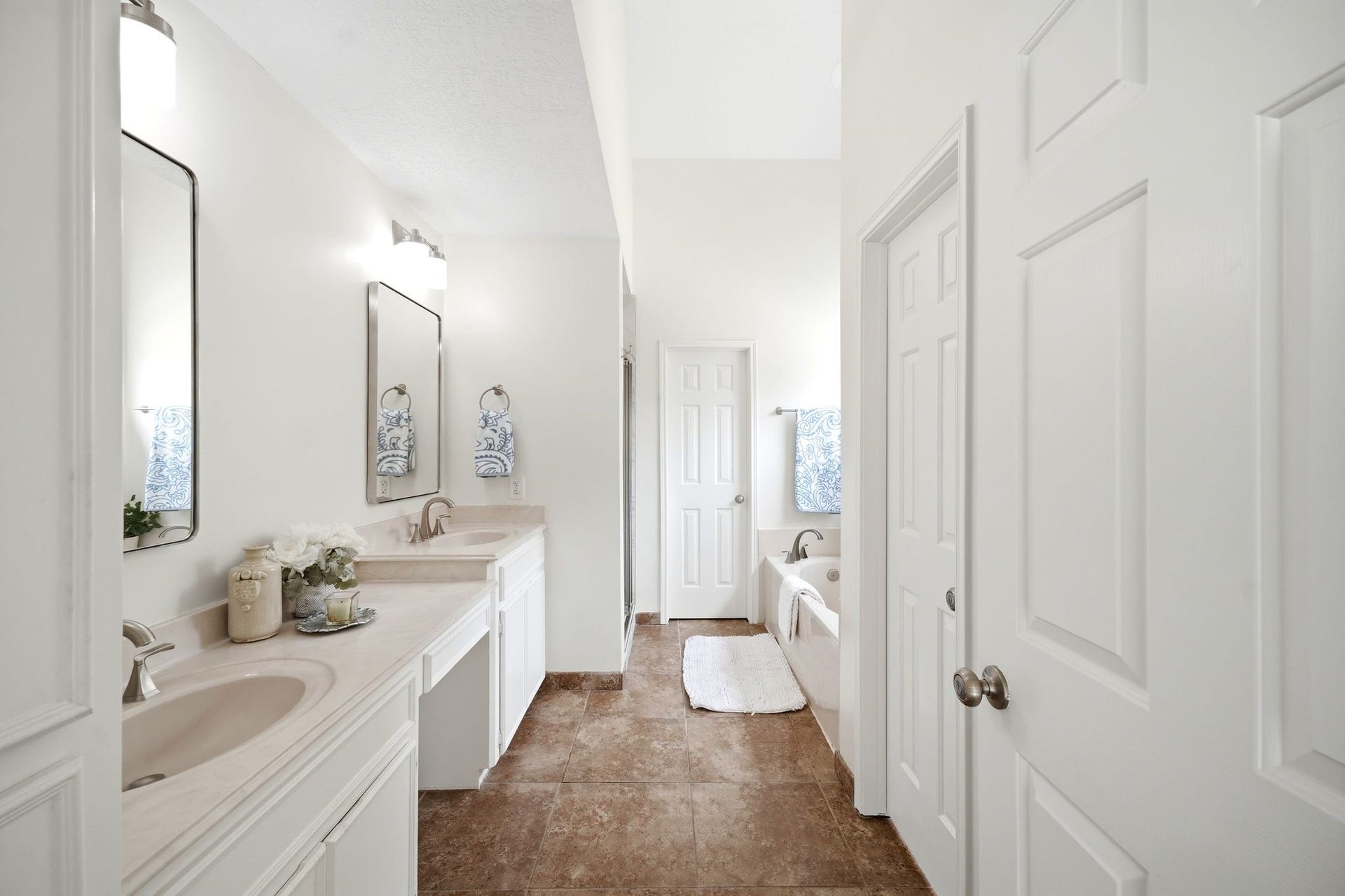2216 Fairwater Park Drive, League City, TX 77573 Discover a spacious and inviting bathroom featuring a double vanity with elegant fixtures, enhanced by a large mirror and serene neutral tones.