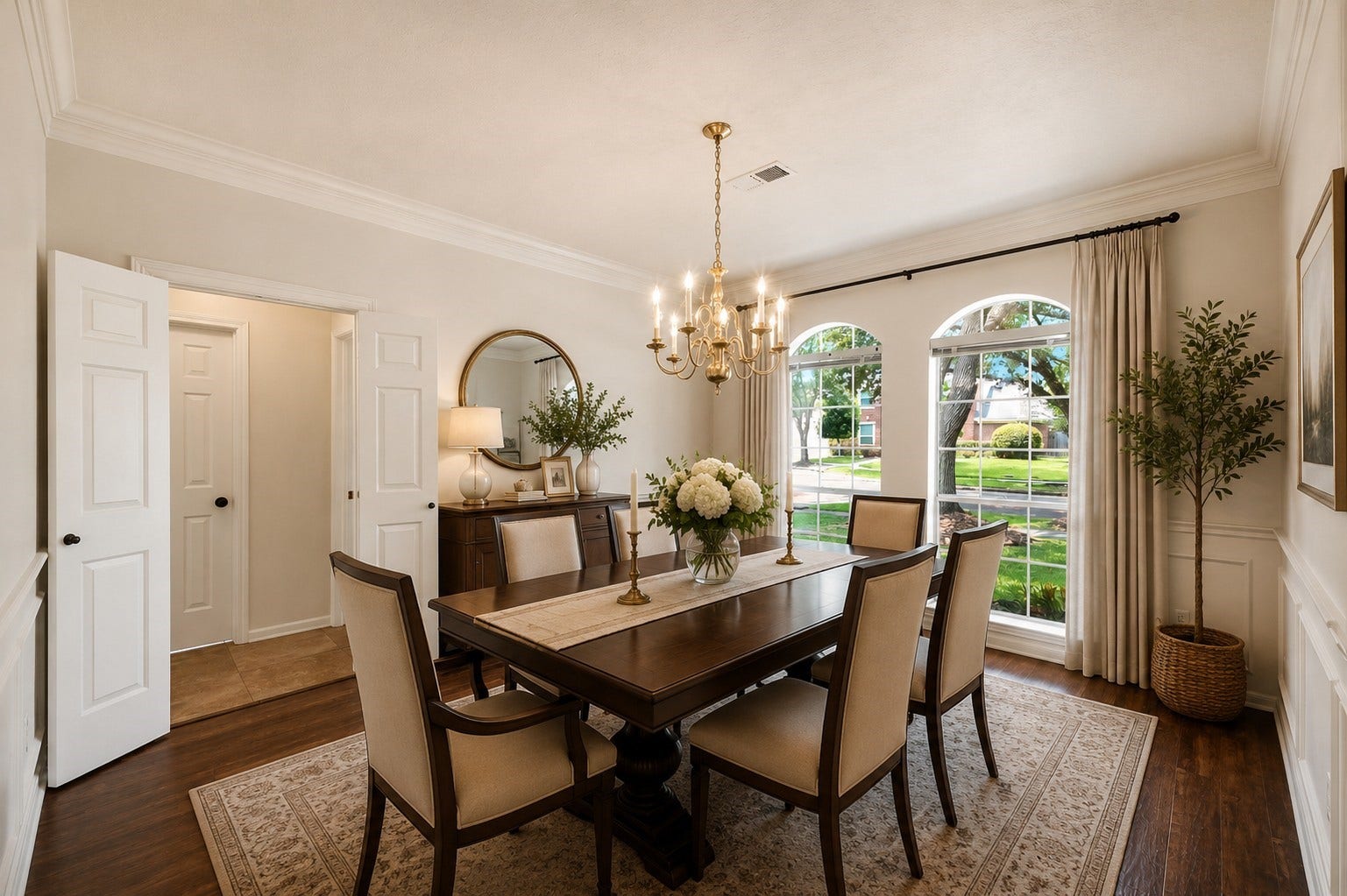 2216 Fairwater Park Drive, League City, TX 77573 Elegantly brightened by two arched windows with serene outdoor views, this dining room offers seamless access to the kitchen, ideal for effortless entertaining.