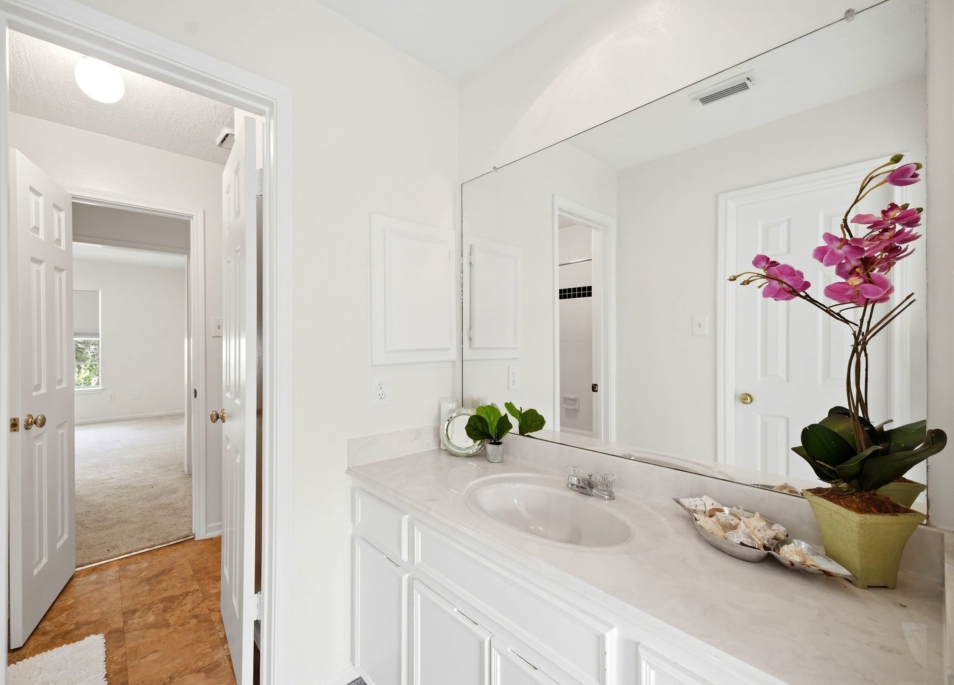 2216 Fairwater Park Drive, League City, TX 77573 Experience the elegance of a bright bathroom featuring a large mirror and a separate vanity, perfect for a refreshing start to your day.