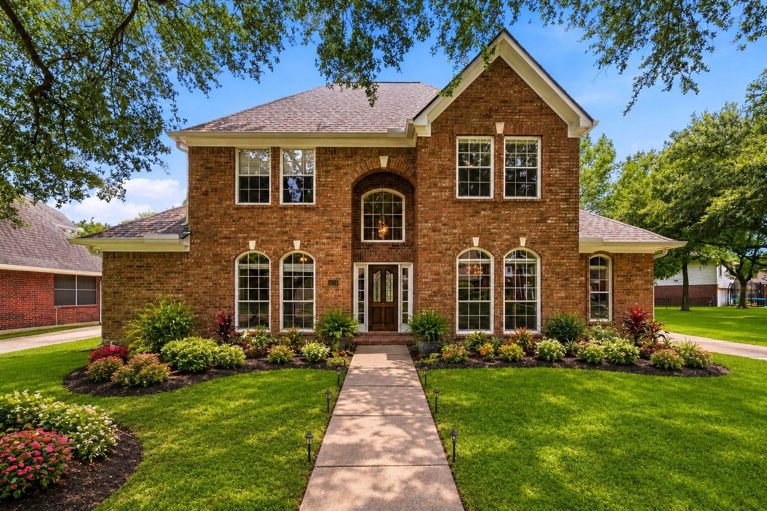 2216 Fairwater Park Drive, League City, TX 77573 Charming brick home with an inviting facade, set amidst lush landscaping and boasting a brand-new roof for peace of mind.