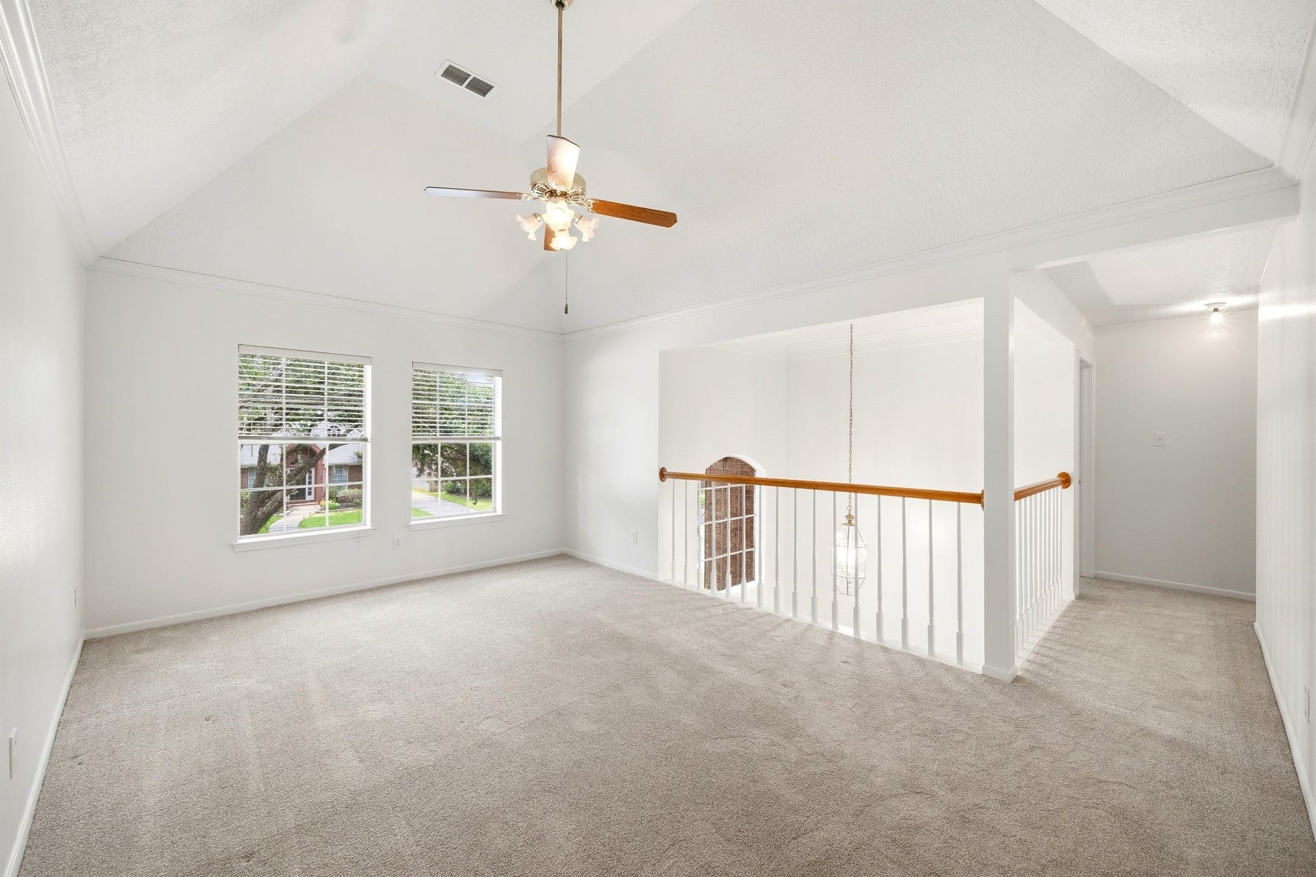 2216 Fairwater Park Drive, League City, TX 77573 The gameroom, overlooking a stairway with an elegant railing, offers a versatile space perfect for a living area or loft.