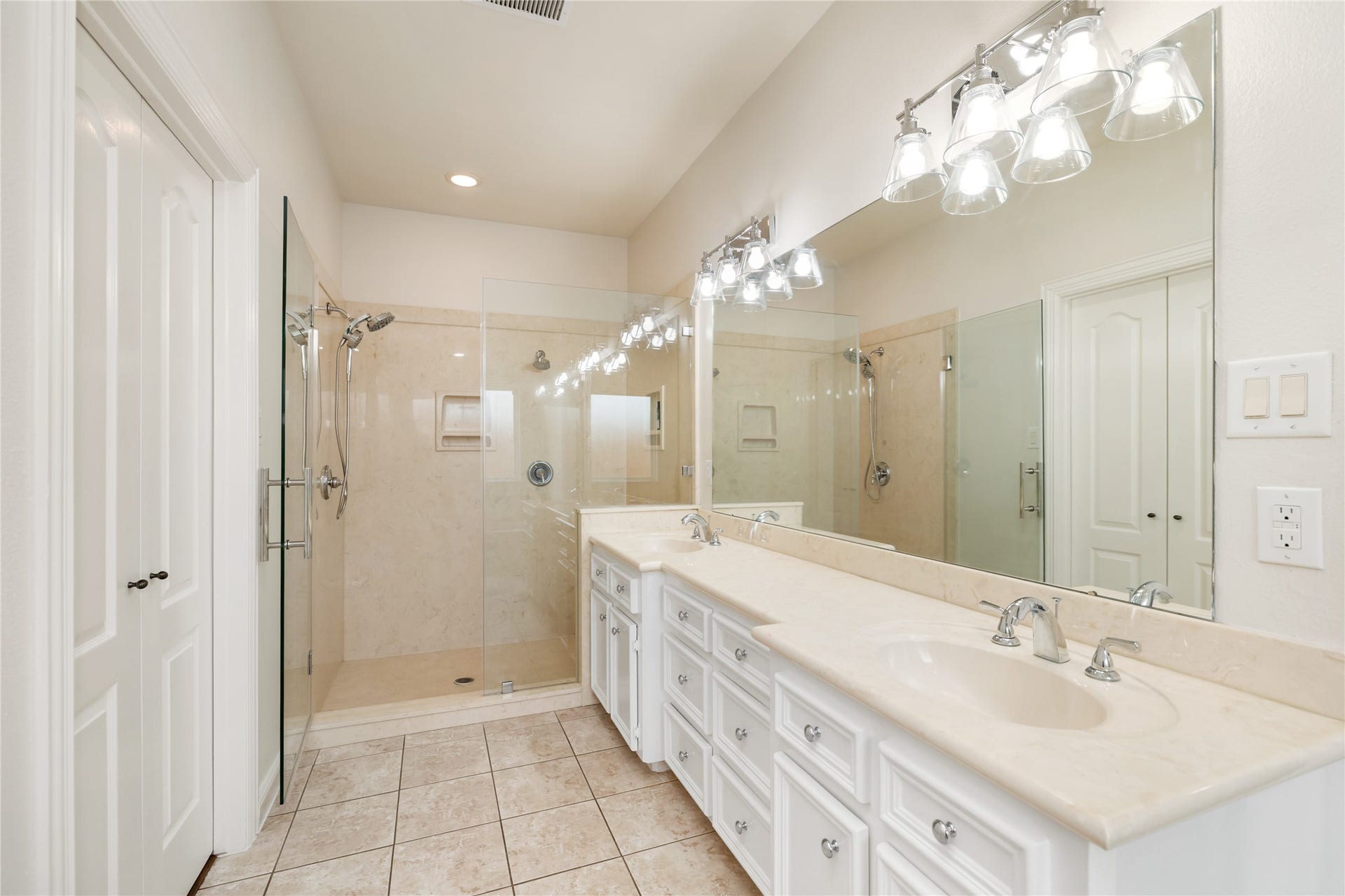 Primary bathroom with frameless glass shower and new plumbing fixtures throughout