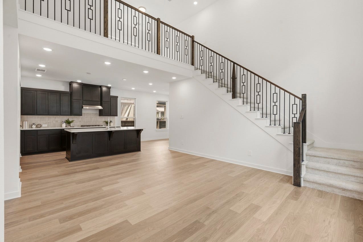 3431 Loam Lane, Richmond, TX 77406 The open family room flows seamlessly into the kitchen, complemented by a beautiful baluster staircase that adds warmth and timeless architectural character.