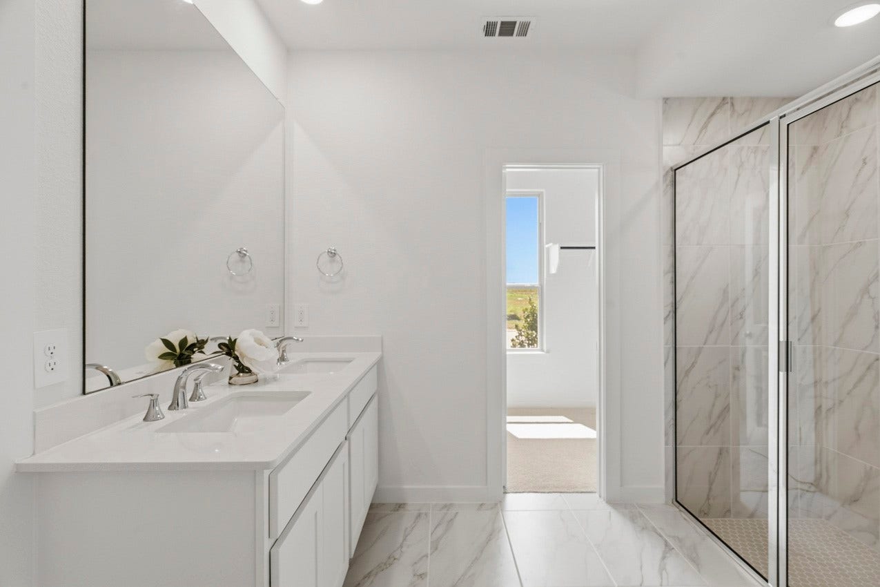 3431 Loam Lane, Richmond, TX 77406 The primary bathroom offers a serene, spa-like retreat with elegant finishes and a calming sense of luxury.