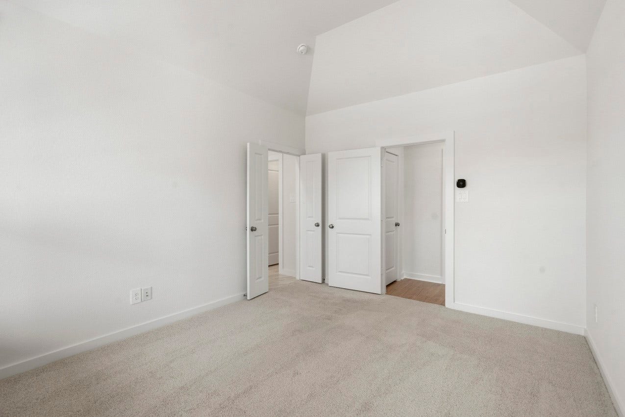 3431 Loam Lane, Richmond, TX 77406 The cozy primary bedroom features French doors opening to a serene primary bathroom, creating a seamless and inviting retreat.