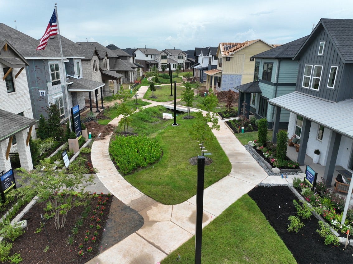 3431 Loam Lane, Richmond, TX 77406 Indigo Mews offers a charming, tree-lined setting with lush shrubs and inviting outdoor spaces that create a warm neighborhood atmosphere.