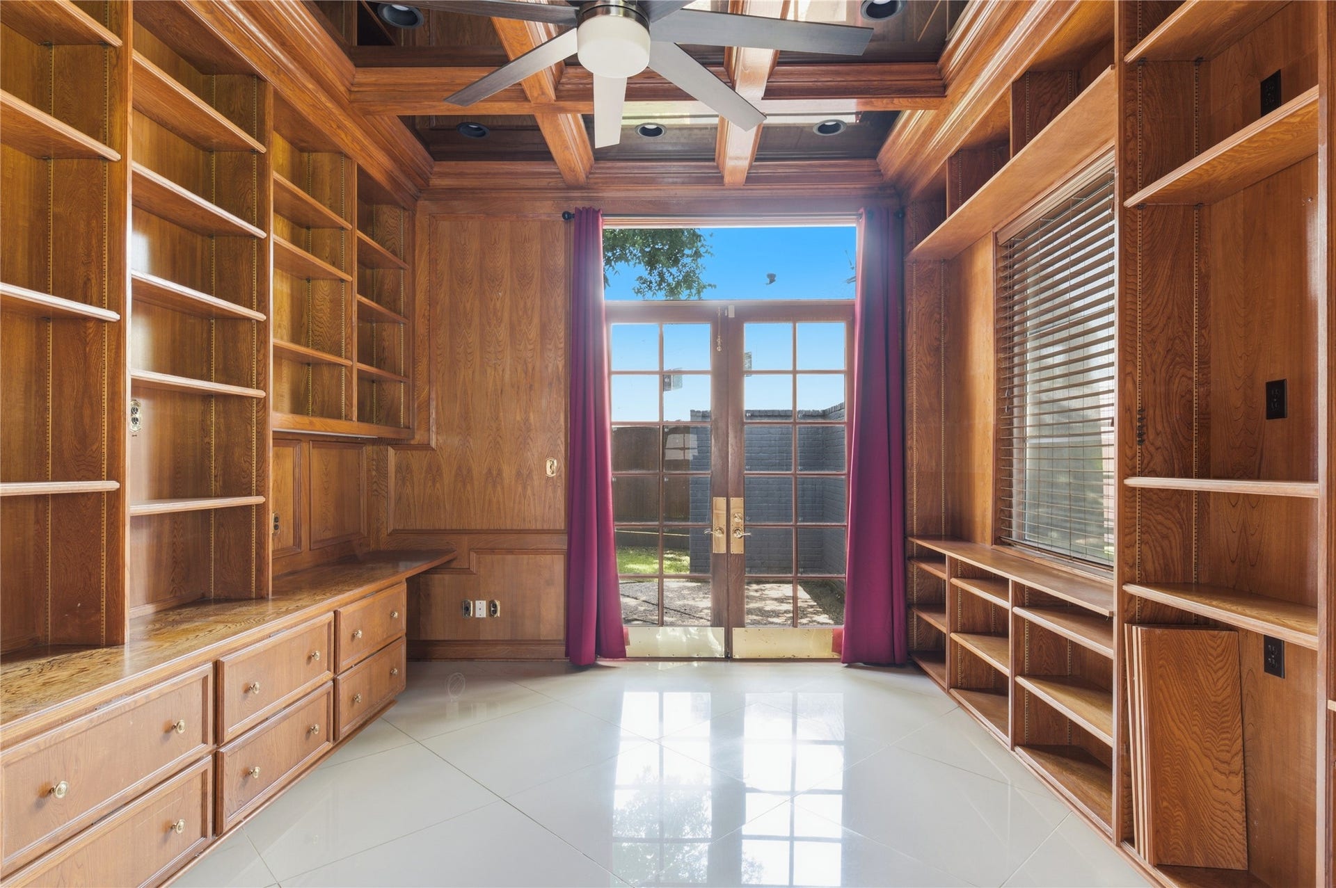 703 Queensmill Court, Houston, TX 77079 Dedicated home office featuring extensive built-in shelving and classic French doors.