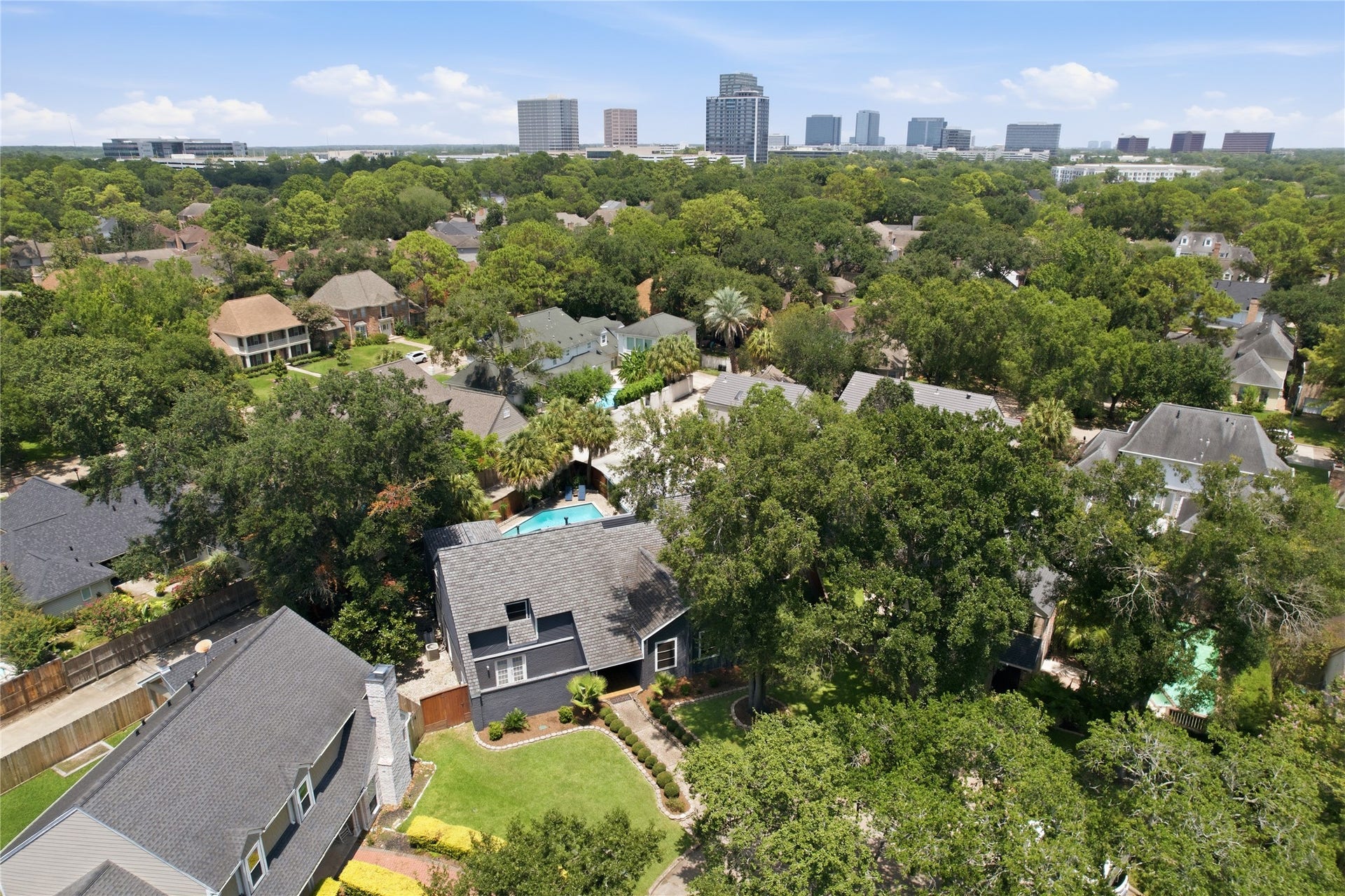 703 Queensmill Court, Houston, TX 77079 Birds-eye perspective of the property and lush surroundings.