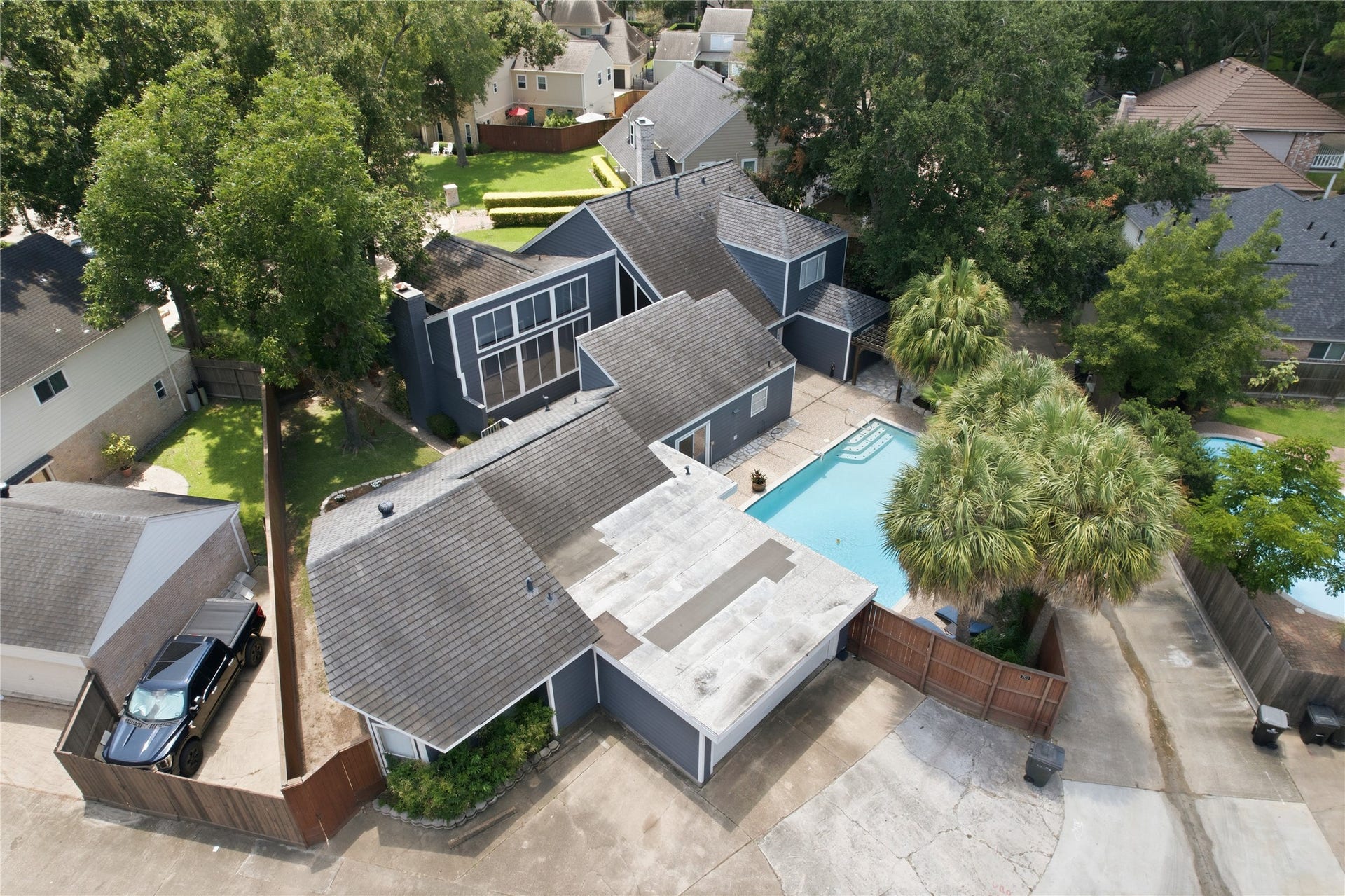 703 Queensmill Court, Houston, TX 77079 Close-up aerial view highlights the large windows and lush palm trees!