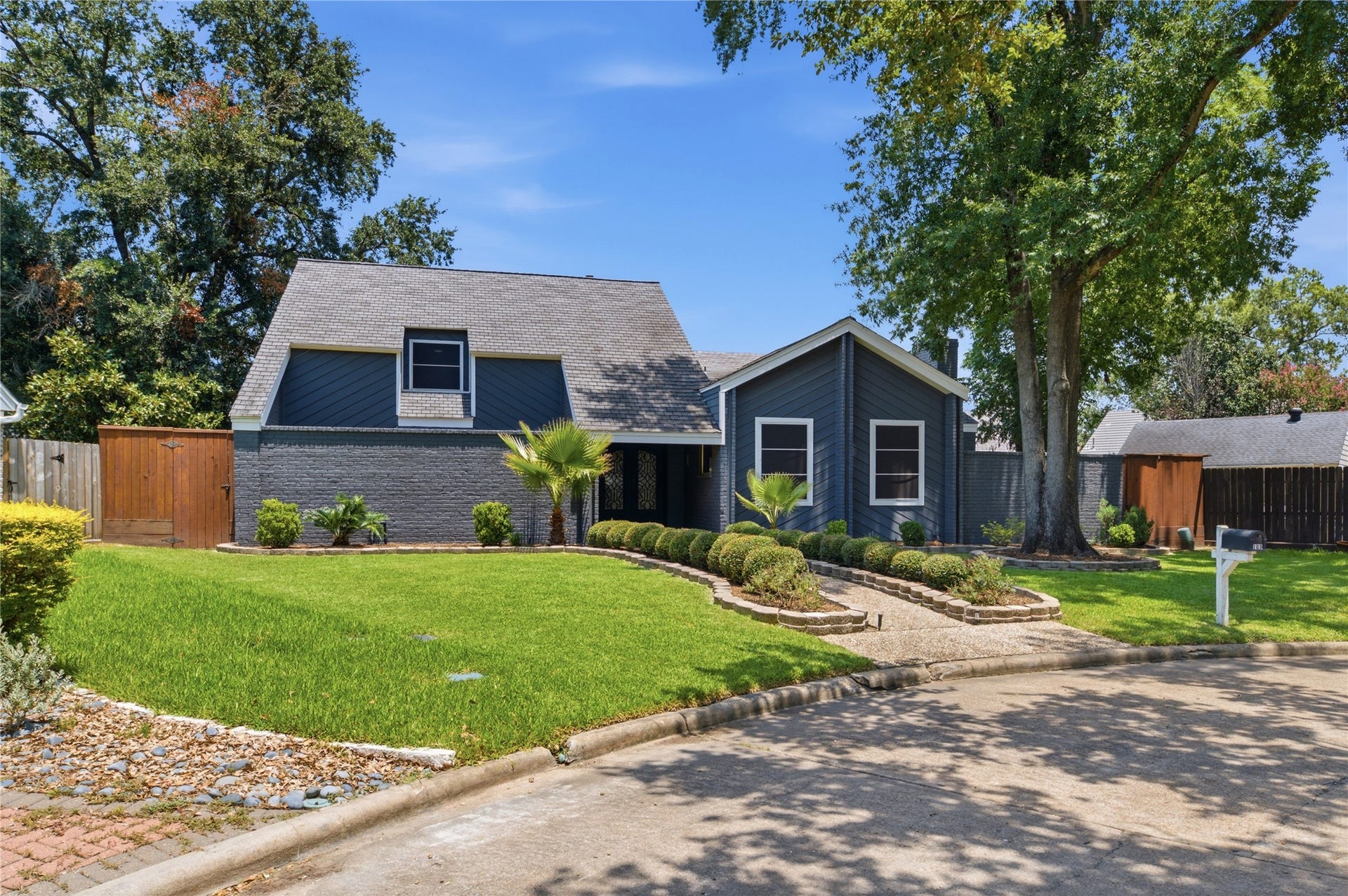 703 Queensmill Court, Houston, TX 77079 Striking mid-century modern curb appeal with mature landscaping.
