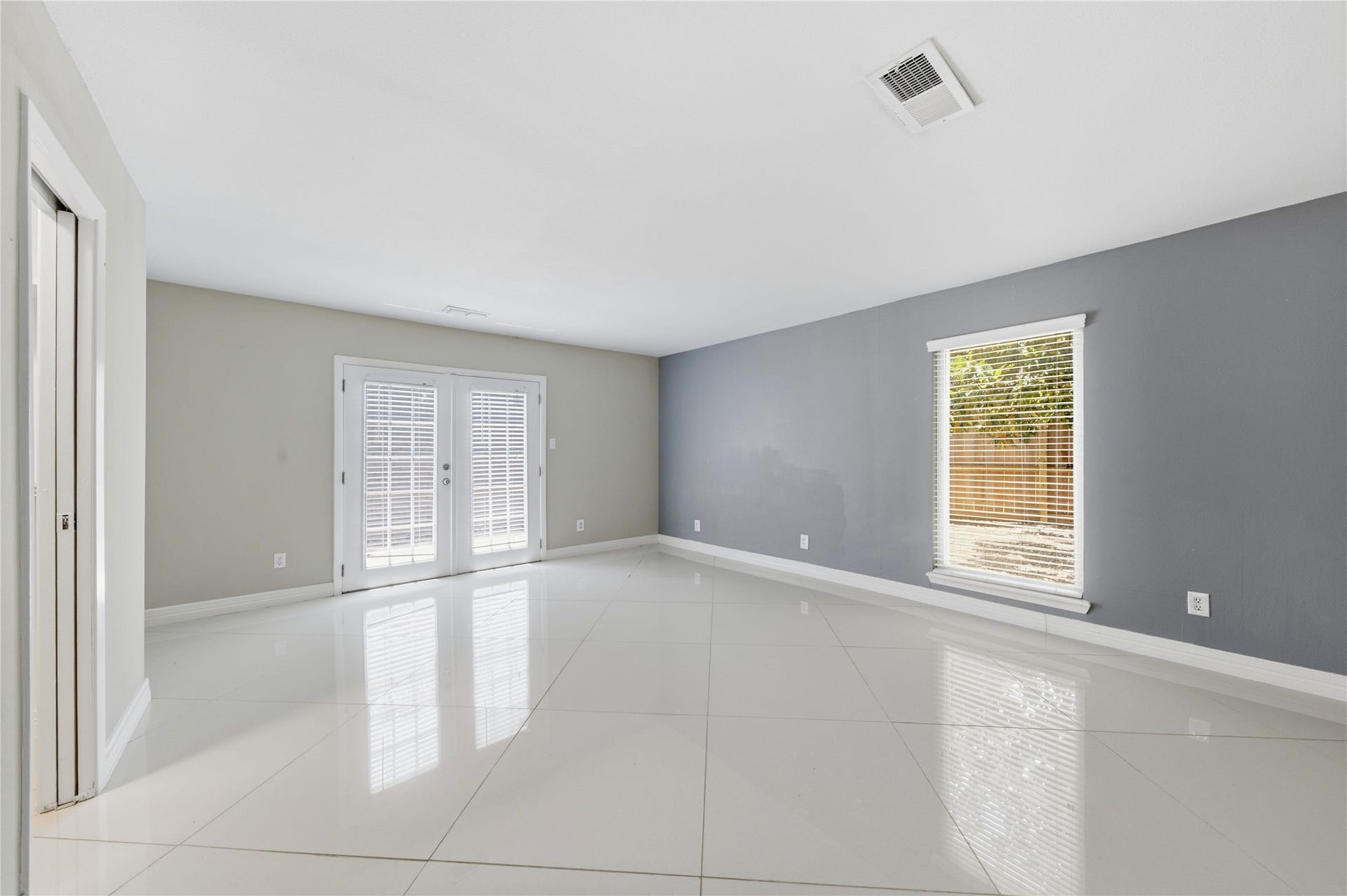 703 Queensmill Court, Houston, TX 77079 Sun-drenched primary suite with direct private access to the backyard patio.