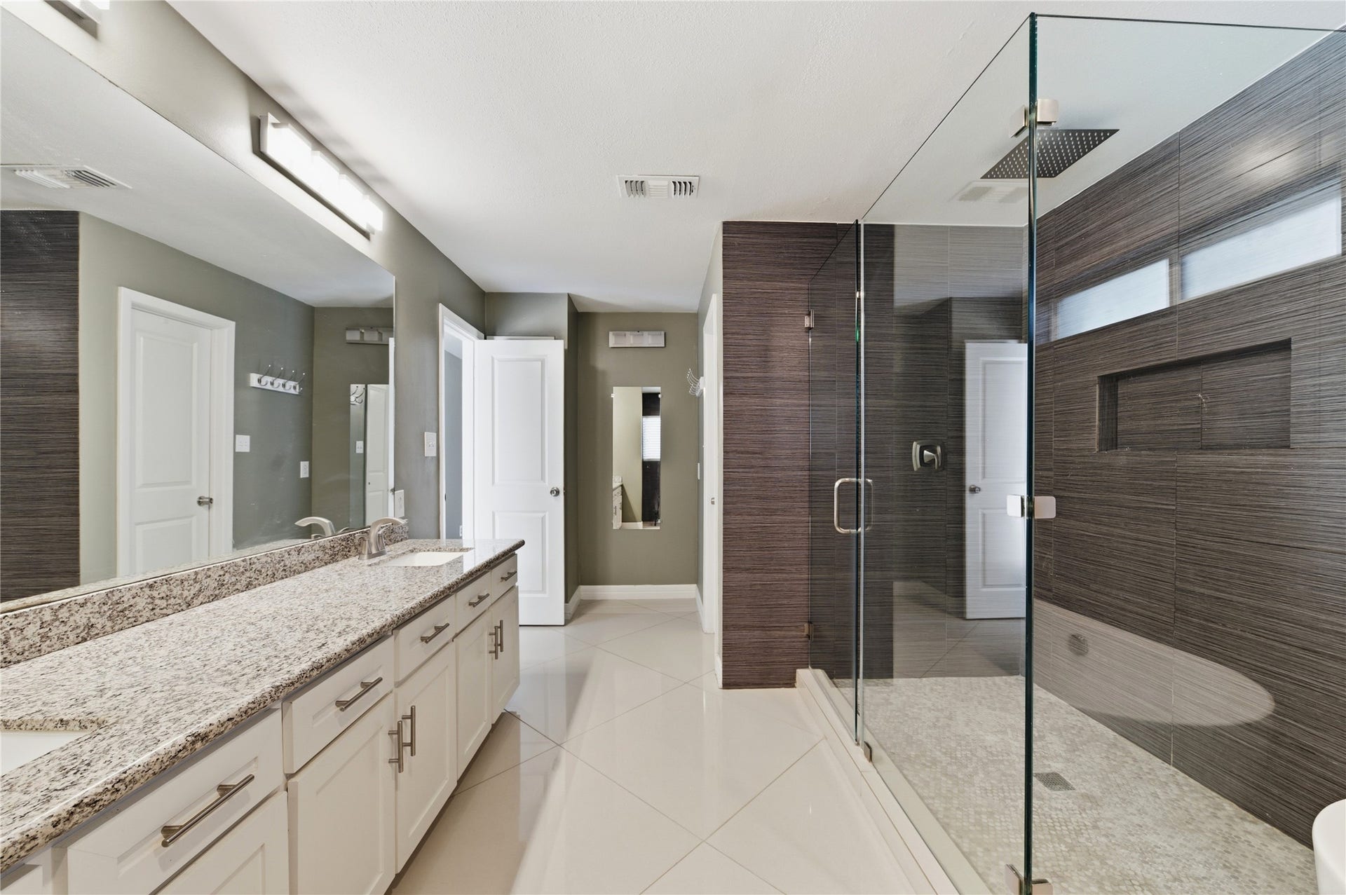 703 Queensmill Court, Houston, TX 77079 Expansive dual-sink vanity with abundant storage.