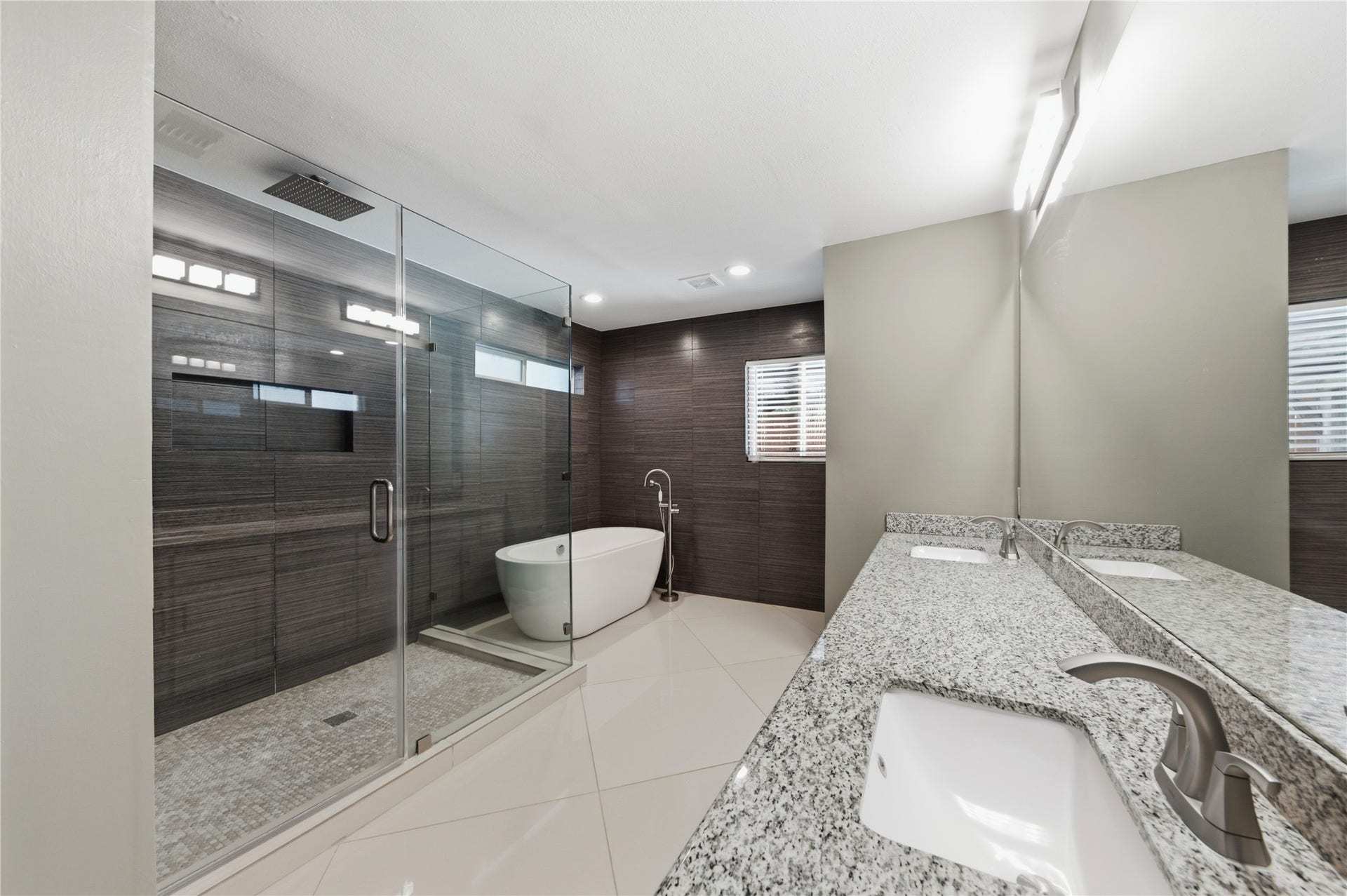 703 Queensmill Court, Houston, TX 77079 Spa-inspired primary bathroom featuring upscale finishes and a deep soaking tub designed for ultimate relaxation.