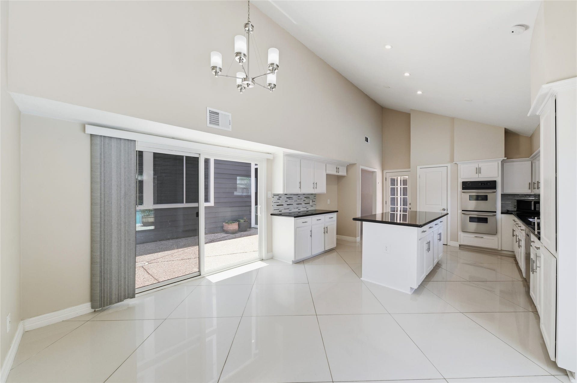 703 Queensmill Court, Houston, TX 77079 Sliding glass doors off the breakfast nook seamless blend indoor and outdoor living.