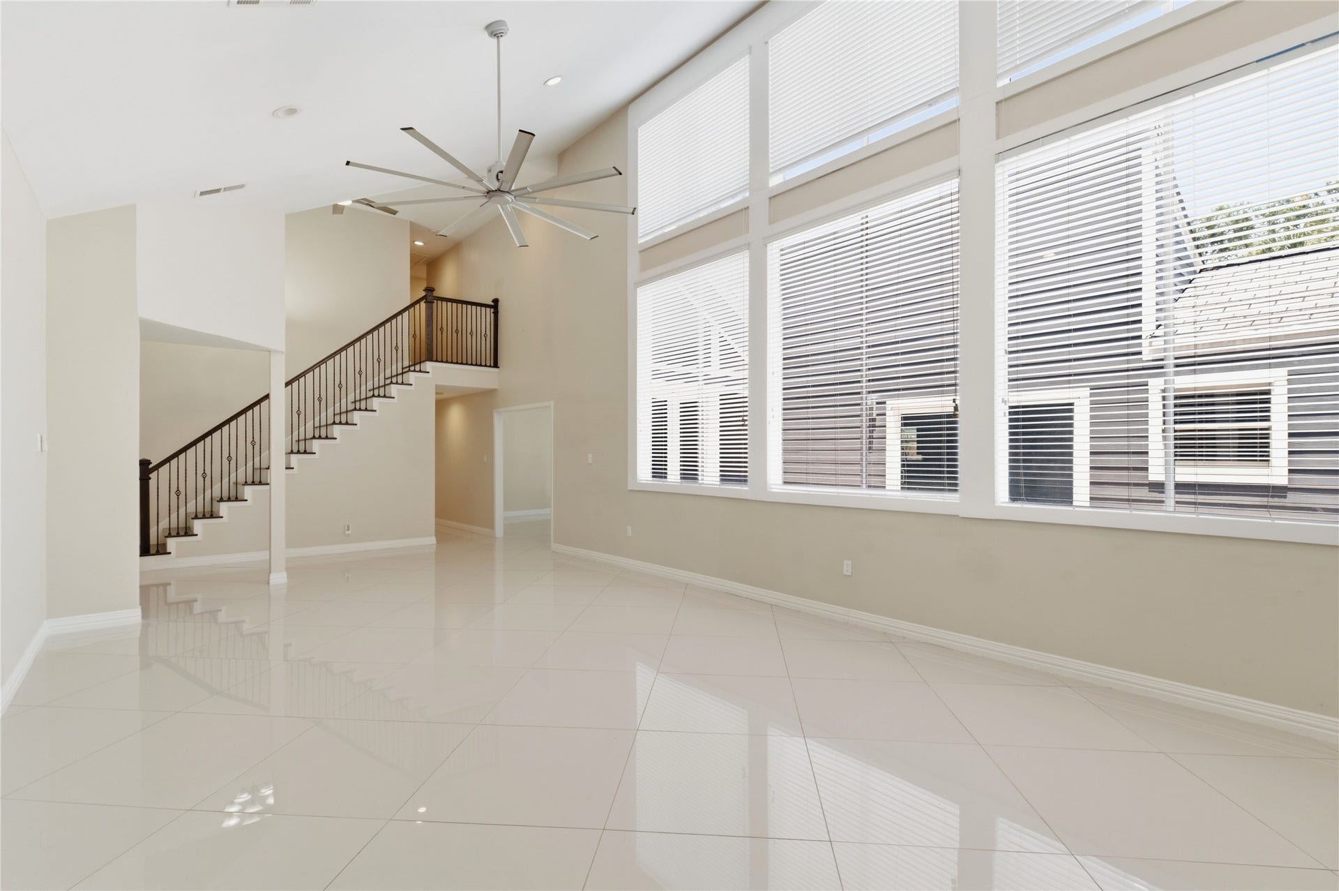 703 Queensmill Court, Houston, TX 77079 Dramatic two-story living room flooded with natural light.