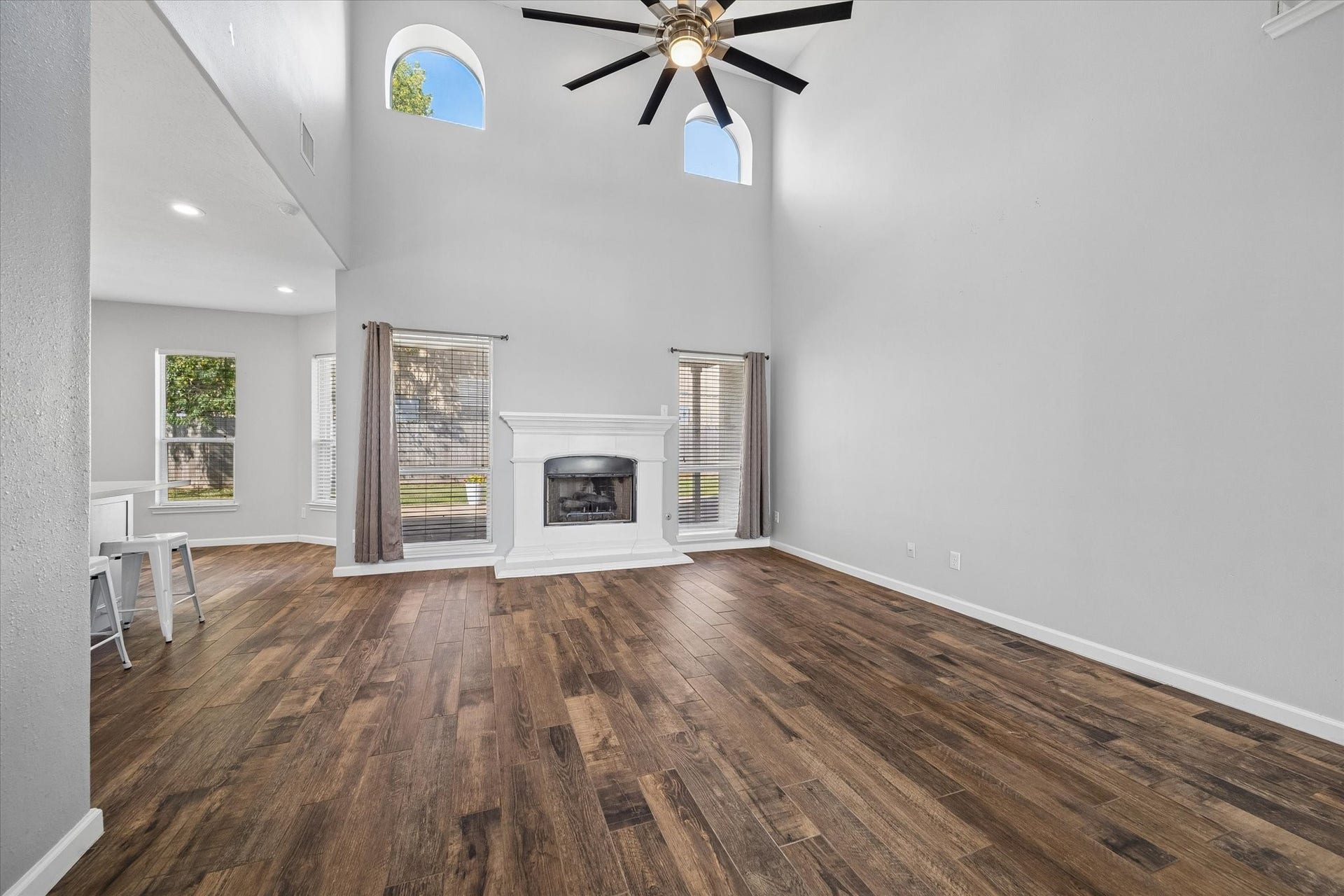 21519 Black Opal Lane, Kingwood, TX 77339 Two-story HIGH CEILINGS and double arched windows let sunlight stream into the living room. A gorgeous gas-log fireplace anchors the room.