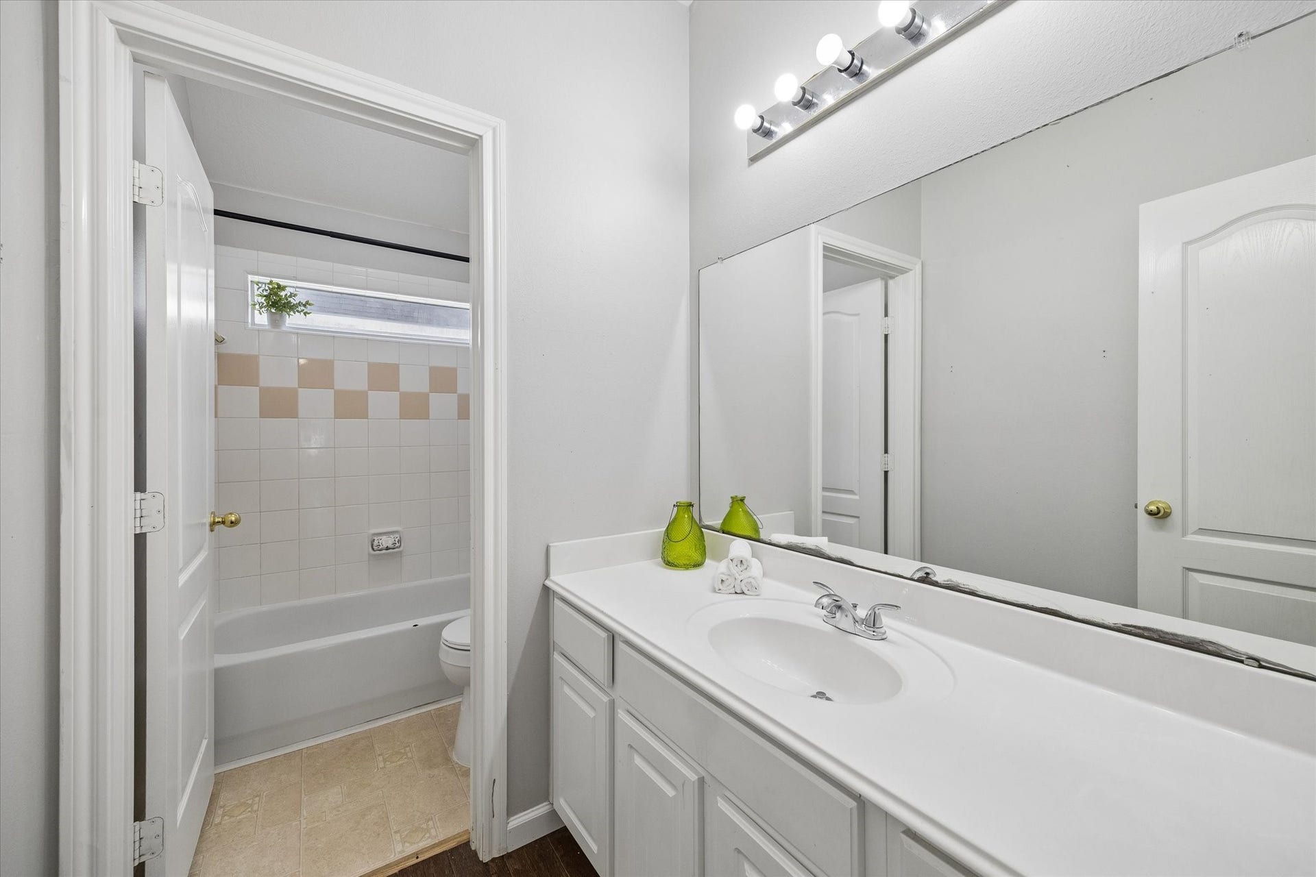 21519 Black Opal Lane, Kingwood, TX 77339 The shared guest bathroom features a separate vanity and shower area making morning prep easy! A long countertop and vanity lets everyone have space to keep toiletries handy.