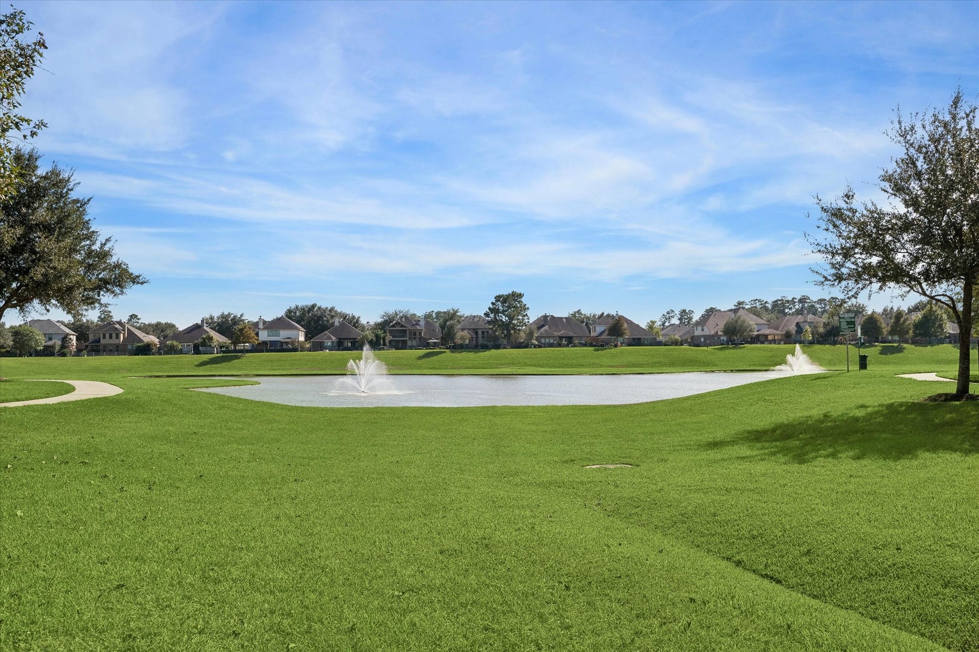 21519 Black Opal Lane, Kingwood, TX 77339 Beautiful neighborhood lake surrounded by a walking/jogging trail at the main entrance to the community.