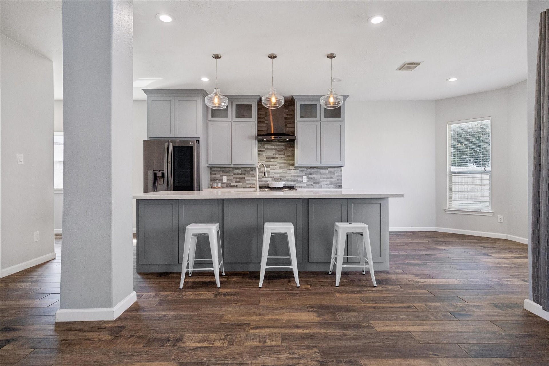21519 Black Opal Lane, Kingwood, TX 77339 You'll love this MODERNIZED KITCHEN with a huge island, sunny breakfast area, upscale LG appliances, tall cabinets topped with stacked glass-front cabinets, and more!