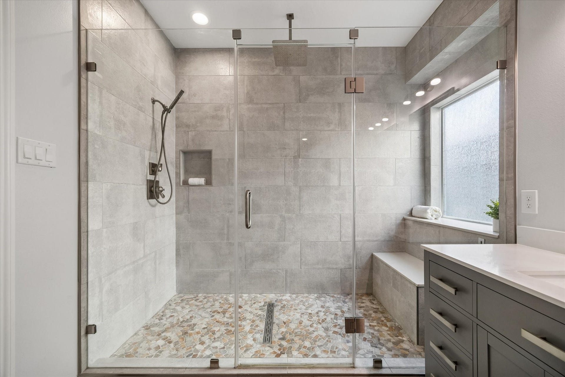 21519 Black Opal Lane, Kingwood, TX 77339 This amazing HUGE walk-in shower features beautiful tile work, shower wand AND rainhead, wall niche, built-in bench, and a window with privacy glass.
