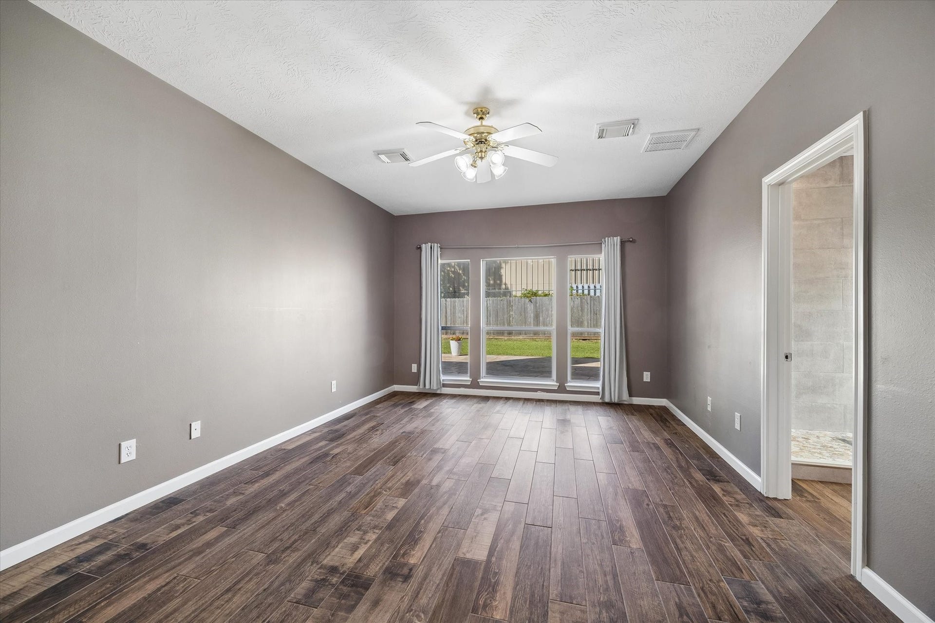 21519 Black Opal Lane, Kingwood, TX 77339 The spacious primary suite is tucked away at the rear of the home on the first floor. Wide windows let sunshine in and provide a view of the backyard. No carpet!
