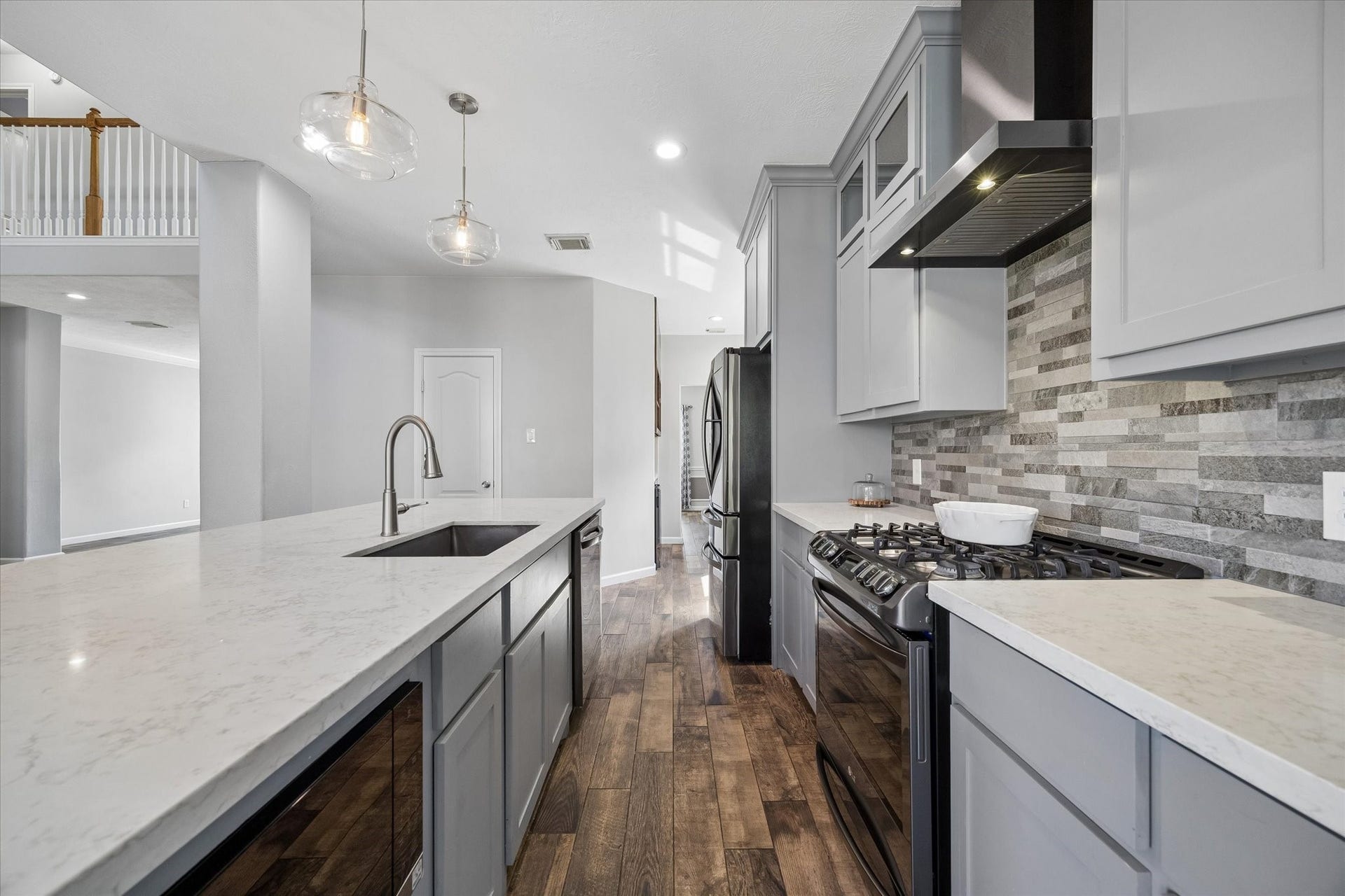 21519 Black Opal Lane, Kingwood, TX 77339 Your new kitchen features high-end LG appliances including a 5-burner gas stove, built-in microwave, and upgraded refrigerator with an INSTA-VIEW DOOR.