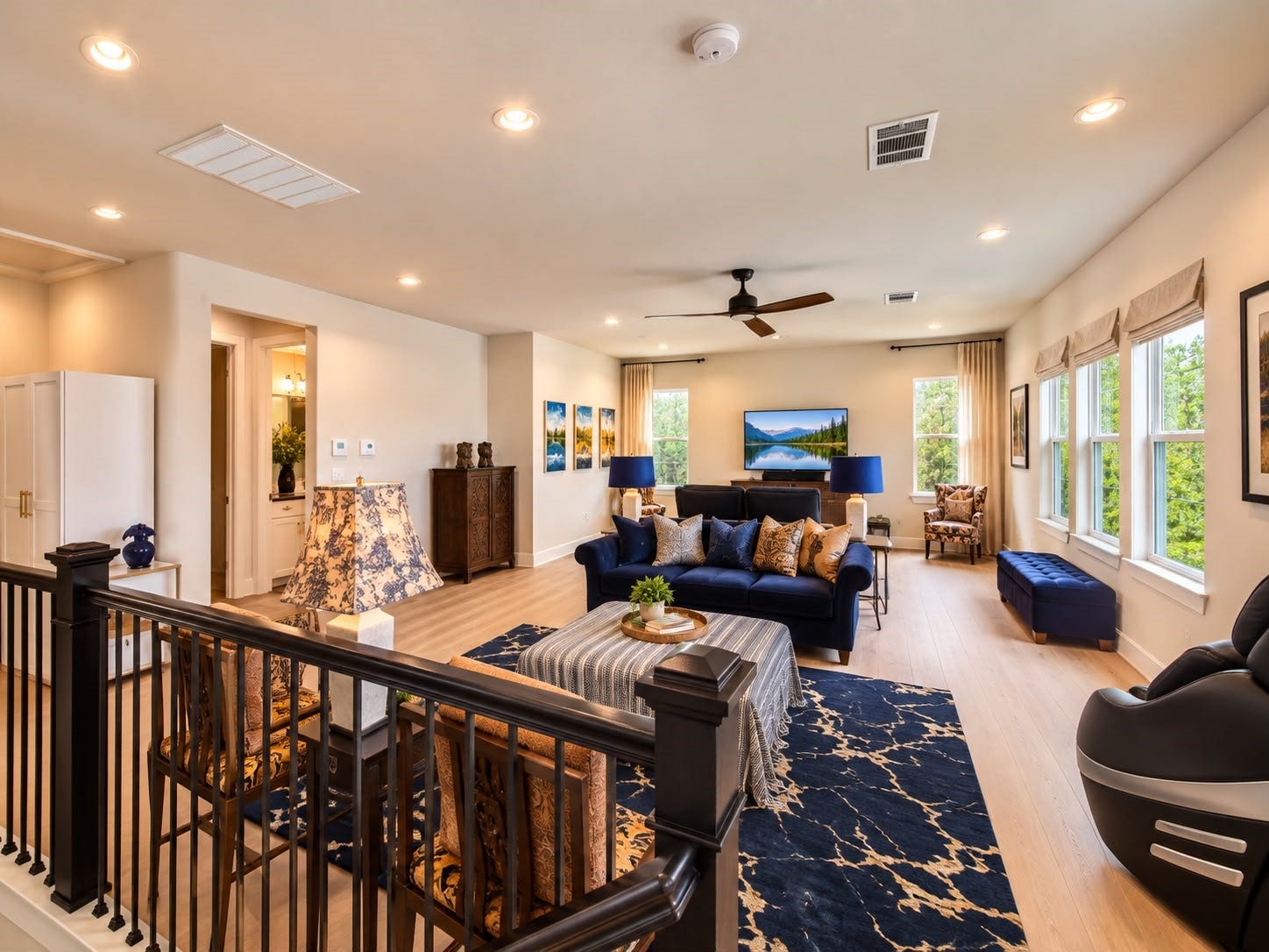 413 Forest Reserve Place, Houston, TX 77079 Bright and spacious living area with large windows, stylish blue seating, elegant accent furnishings, and an open layout ideal for entertaining.