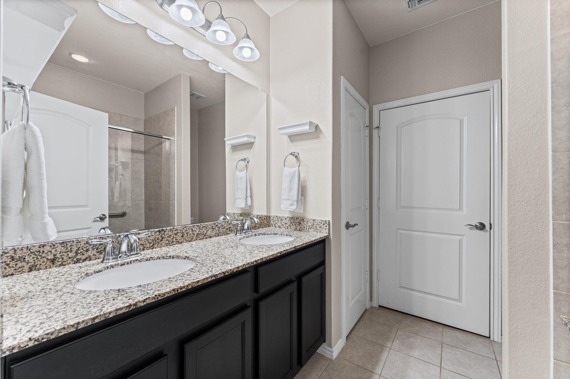 317 Fell Lane, Spring, TX 77382 A commodious double vanity setup combined with generous cabinet storage and an integrated linen closet offers the ultimate blend of luxury and practical layout design