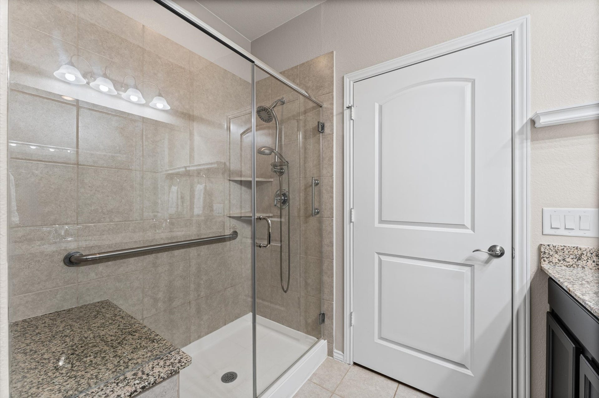 317 Fell Lane, Spring, TX 77382 Integrating a double shower head setup, seating, and crucial universal accessibility features like a grab bar within a sleek, modern aesthetic creates a high-performance, spa-like sanctuary.