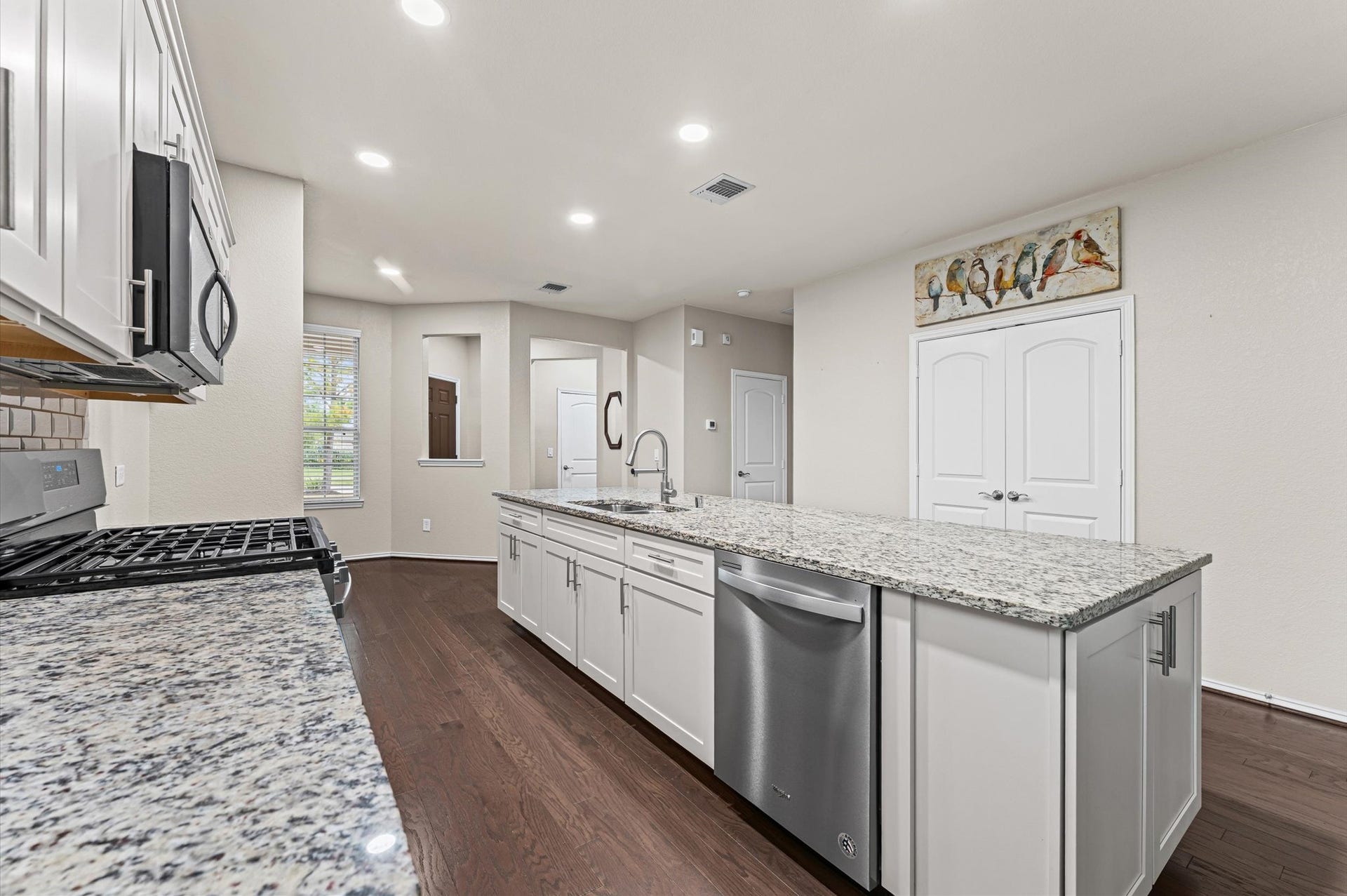 317 Fell Lane, Spring, TX 77382 This kitchen features a highly convenient pantry and cabinets at the end of the island to provide plenty of storage for all your kitchen essentials.