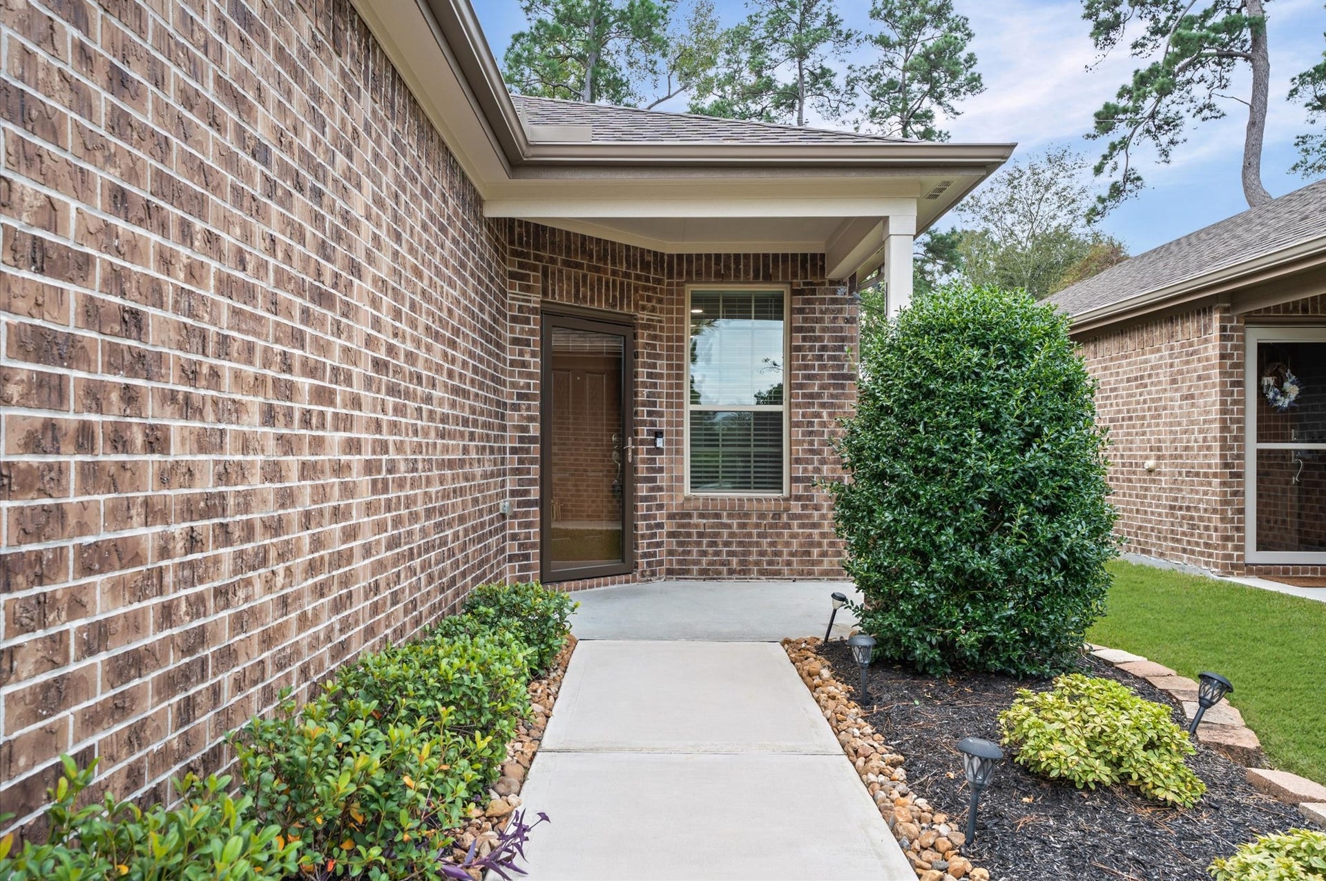 317 Fell Lane, Spring, TX 77382 A stunning front porch with a glass security door establishes an immediate tone of sophisticated curb appeal while providing an inviting, secure transition into this beautiful home.