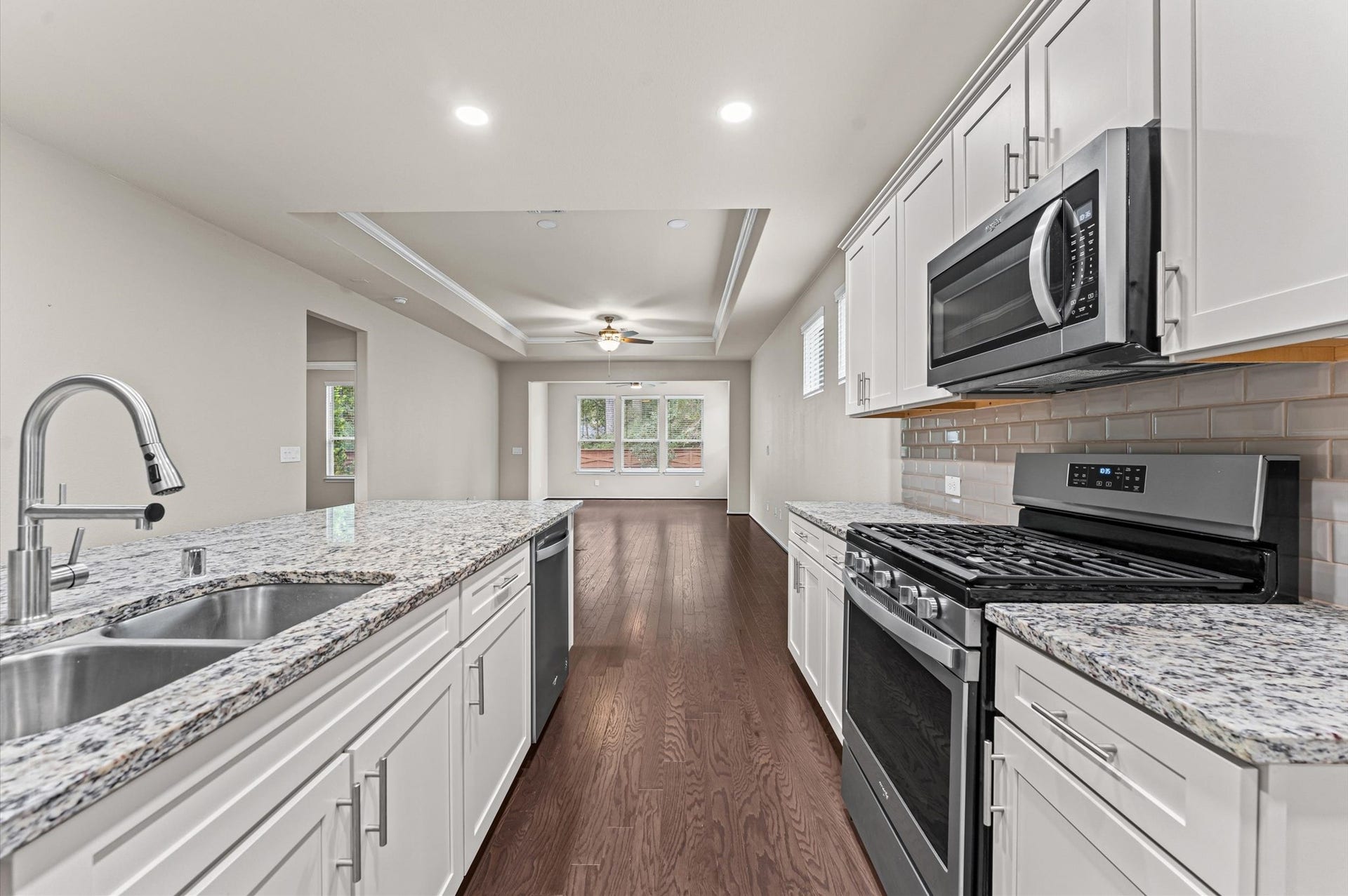 317 Fell Lane, Spring, TX 77382 Fully equipped for culinary enthusiasts, the kitchen showcases premium, matching stainless steel appliances that deliver professional performance, durability, and a sleek modern aesthetic.