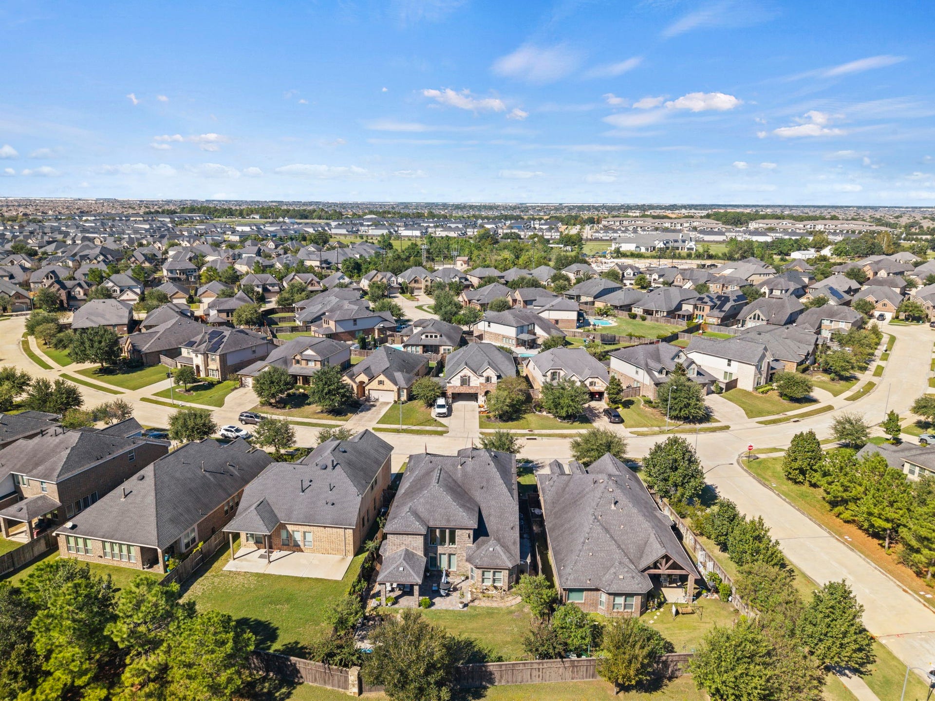 28107 Scenic Shore Lane, Fulshear, TX 77441 Nestled in a sprawling suburban neighborhood, this home sits on a tree-lined street with well-maintained yards and modern architecture, offering a serene and family-friendly environment.