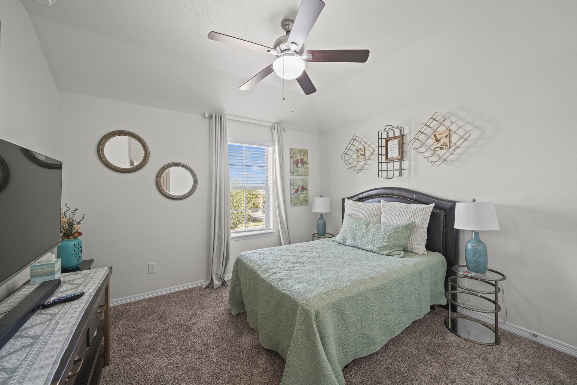 28107 Scenic Shore Lane, Fulshear, TX 77441 Cozy bedroom featuring a comfortable bed, elegant decor, and a large window allowing natural light to brighten the space.