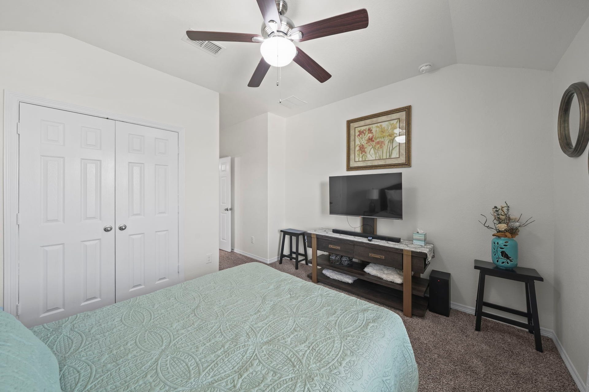 28107 Scenic Shore Lane, Fulshear, TX 77441 Cozy bedroom featuring a ceiling fan, dual closets, and a mounted TV for relaxed viewing.