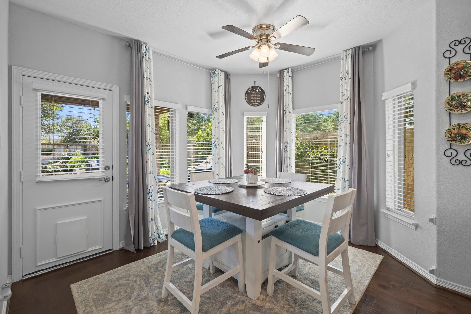 28107 Scenic Shore Lane, Fulshear, TX 77441 Bright and inviting breakfast nook with abundant natural light, featuring large windows, a stylish ceiling fan, and a cozy dining area perfect for morning gatherings.