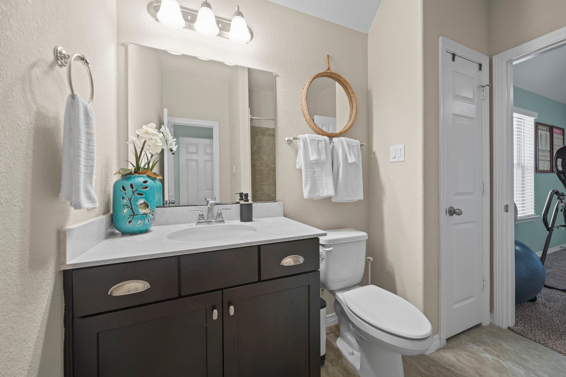 28107 Scenic Shore Lane, Fulshear, TX 77441 Charming bathroom featuring a sleek vanity with ample storage, stylish mirror accents, and a modern light fixture. The neutral tones create a calming atmosphere, complemented by tasteful decor.