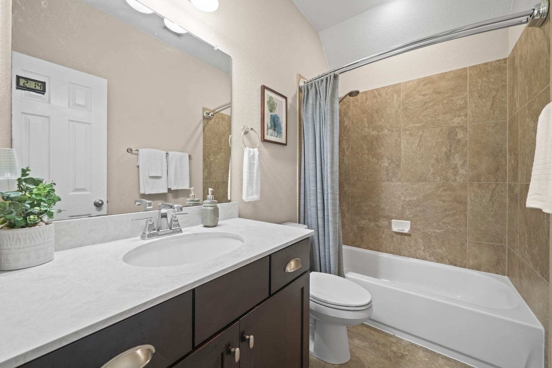 28107 Scenic Shore Lane, Fulshear, TX 77441 Charming bathroom with elegant tilework, a sleek vanity, and a relaxing bathtub, complemented by modern fixtures and ample lighting.