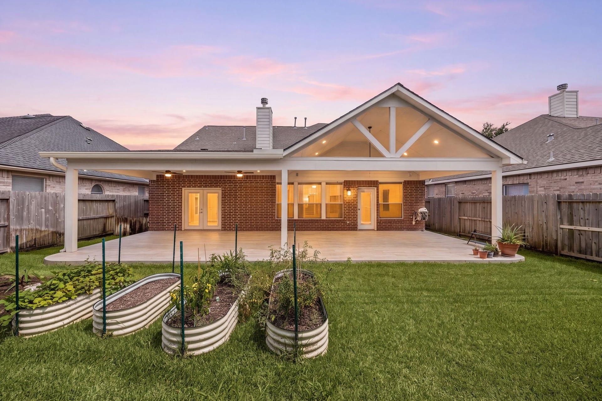 Imagine the possibilities for this massive covered patio! This incredible outdoor living room offers endless space for a full lounge setup, a 10-person dining table, a ping-pong table, or even a custom outdoor kitchen. Complete with recessed lighting and dual ceiling fans, it is the ultimate year-round destination for hosting game days and family barbecues.