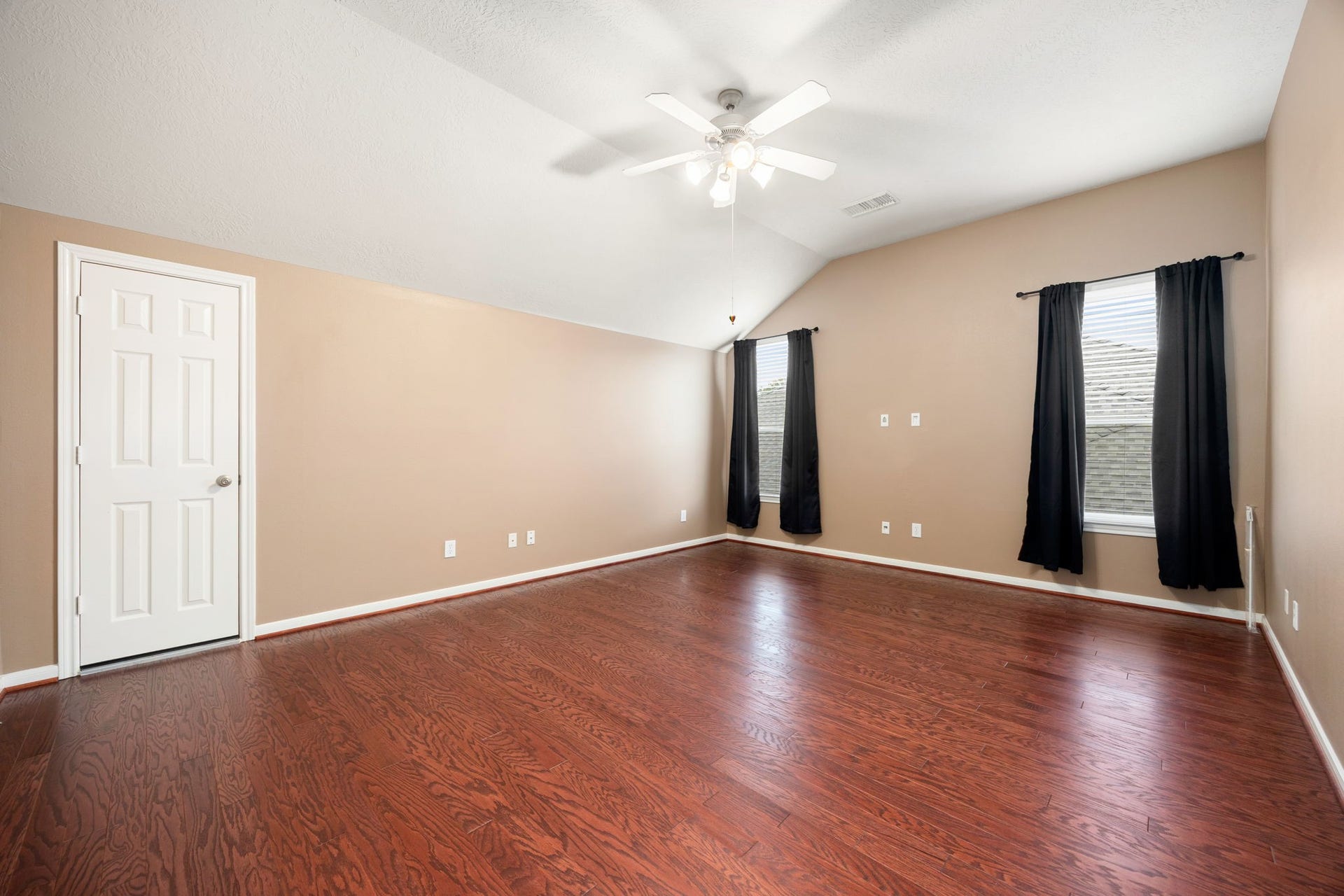Expansive second-floor game room or media room offering endless configuration possibilities for family fun or movie nights. This massive bonus space features premium wood-look flooring, a dramatic vaulted ceiling line, and media-ready outlets.