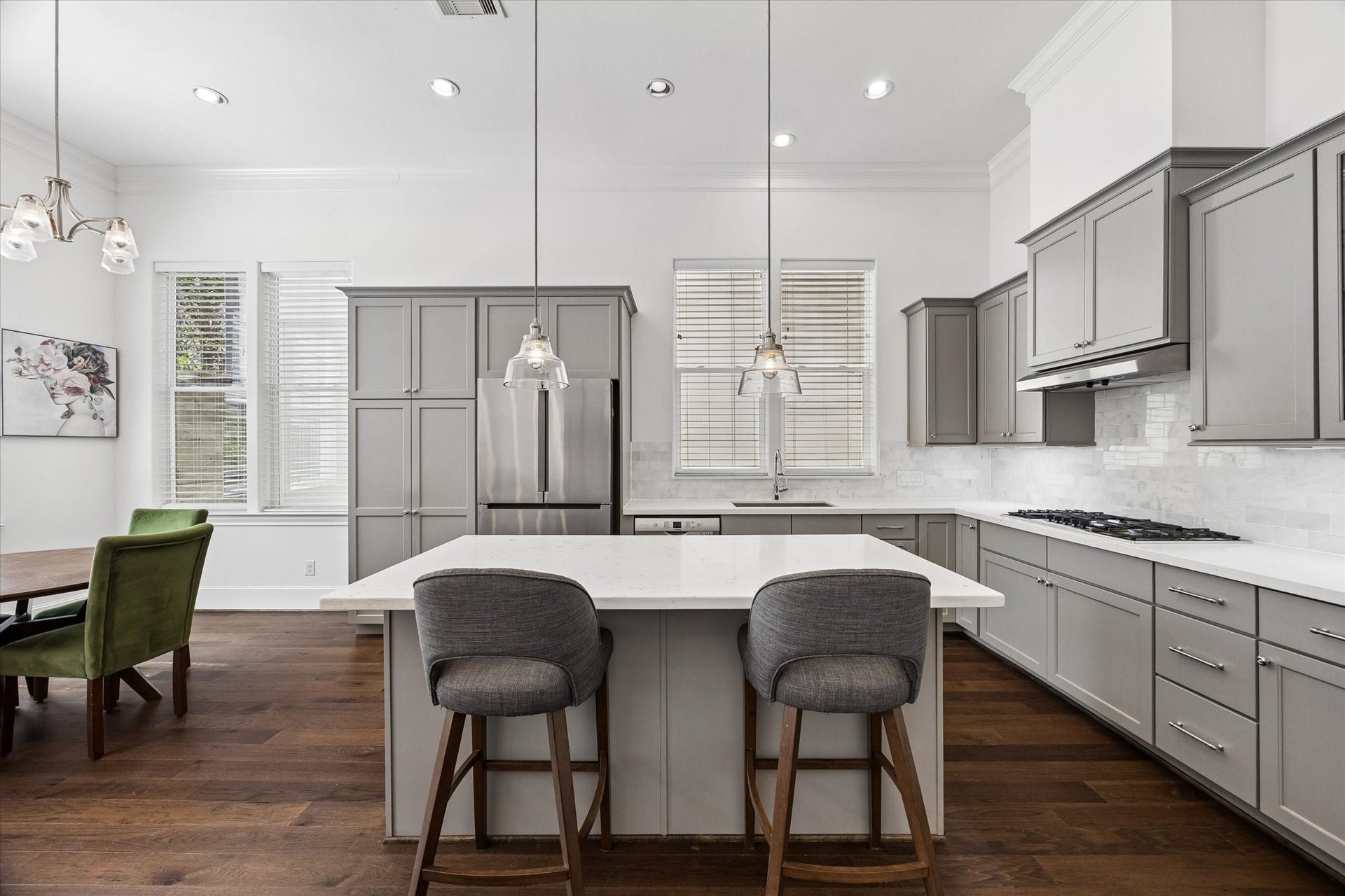 2018 Covent Garden Station, Houston, TX 77045 A chef's dream! Well lit, Kitchen featuring modern aesthetics is perfect for entertaining featuring a large quartz island with breakfast bar seating.