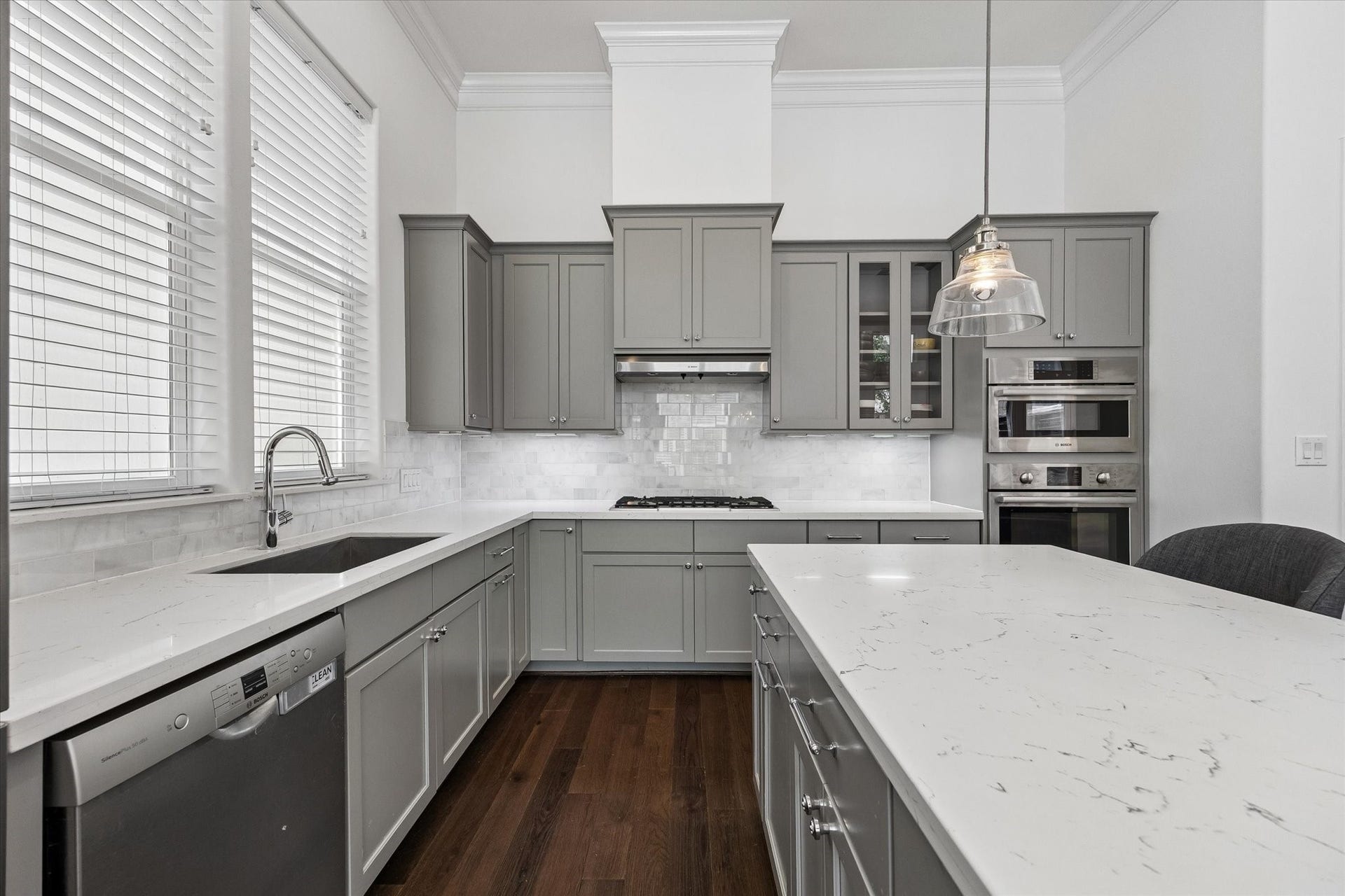 2018 Covent Garden Station, Houston, TX 77045 The Kitchen has 42 inch cabinets with undercabinet lighting highlighting the neutral upgraded backsplash. Outlets are hidden underneath the cabinets, leaving the elegant backsplash uninterrupted. 5 burner cooktop! The wall of windows flood the Kitchen with natural light.