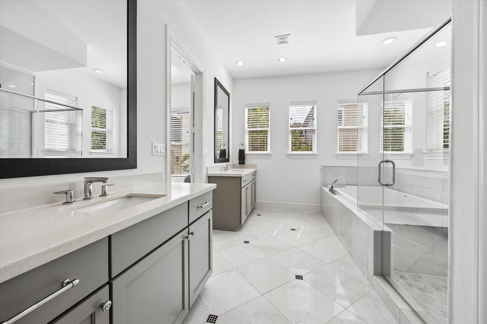 2018 Covent Garden Station, Houston, TX 77045 Double doors open to the Primary Bathroom featuring double vanities with ample cabinet space, seamless glass standing shower, tub, recessed lighting & a homeowner's dream....a large WALK IN closet (One of TWO located in the Primary Bedroom).