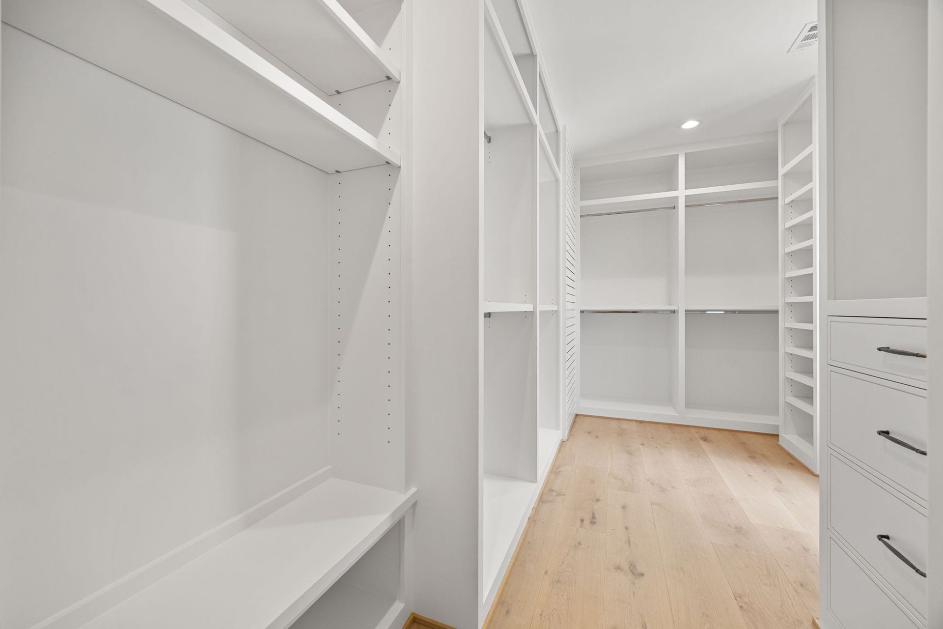 721 Harborside Way, League City, TX 77565 The upstairs primary closet offers abundant custom shelving and cabinetry, providing exceptional organization and storage.