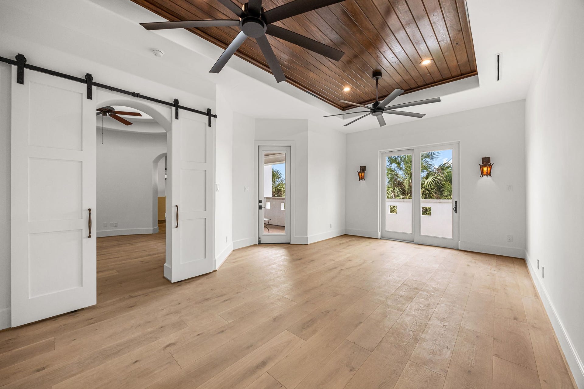 721 Harborside Way, League City, TX 77565 Upstairs, the primary suite is enhanced by a rich wood ceiling and two sets of doors that open to a balcony showcasing serene resort-style views.