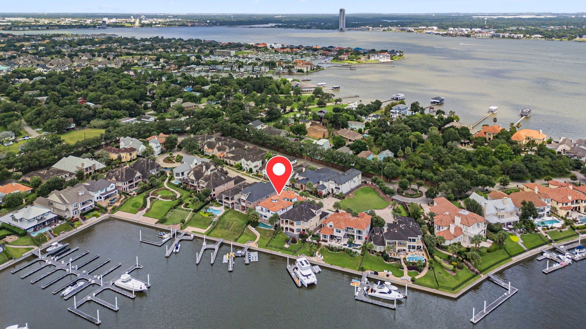 721 Harborside Way, League City, TX 77565 Aerial view of the home and marina highlights its exceptional waterfront setting, offering a more private and less congested location within the harbor.
