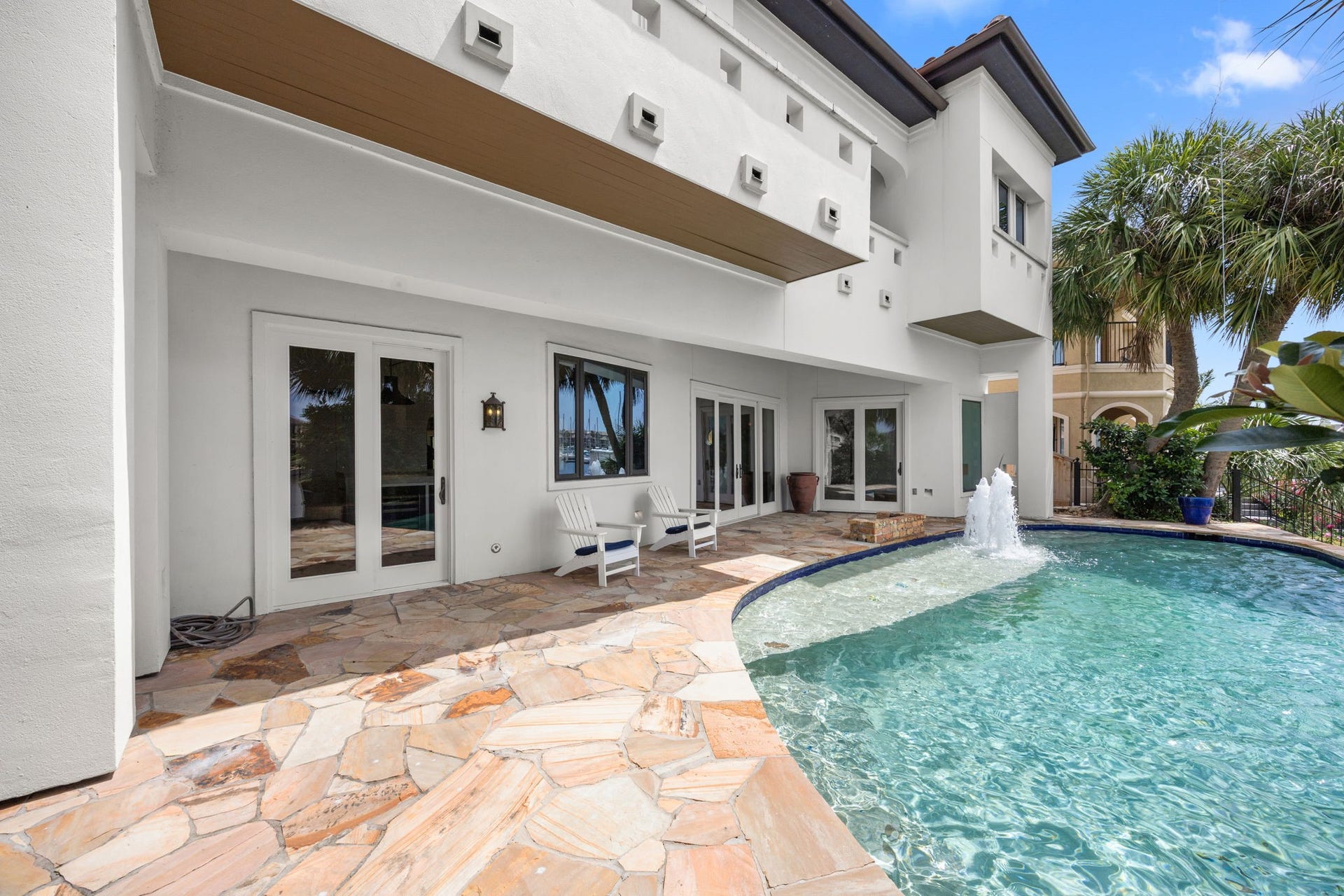 721 Harborside Way, League City, TX 77565 The resort-style pool is enhanced by grand fountains and a dramatic waterfall, creating a stunning backyard oasis.