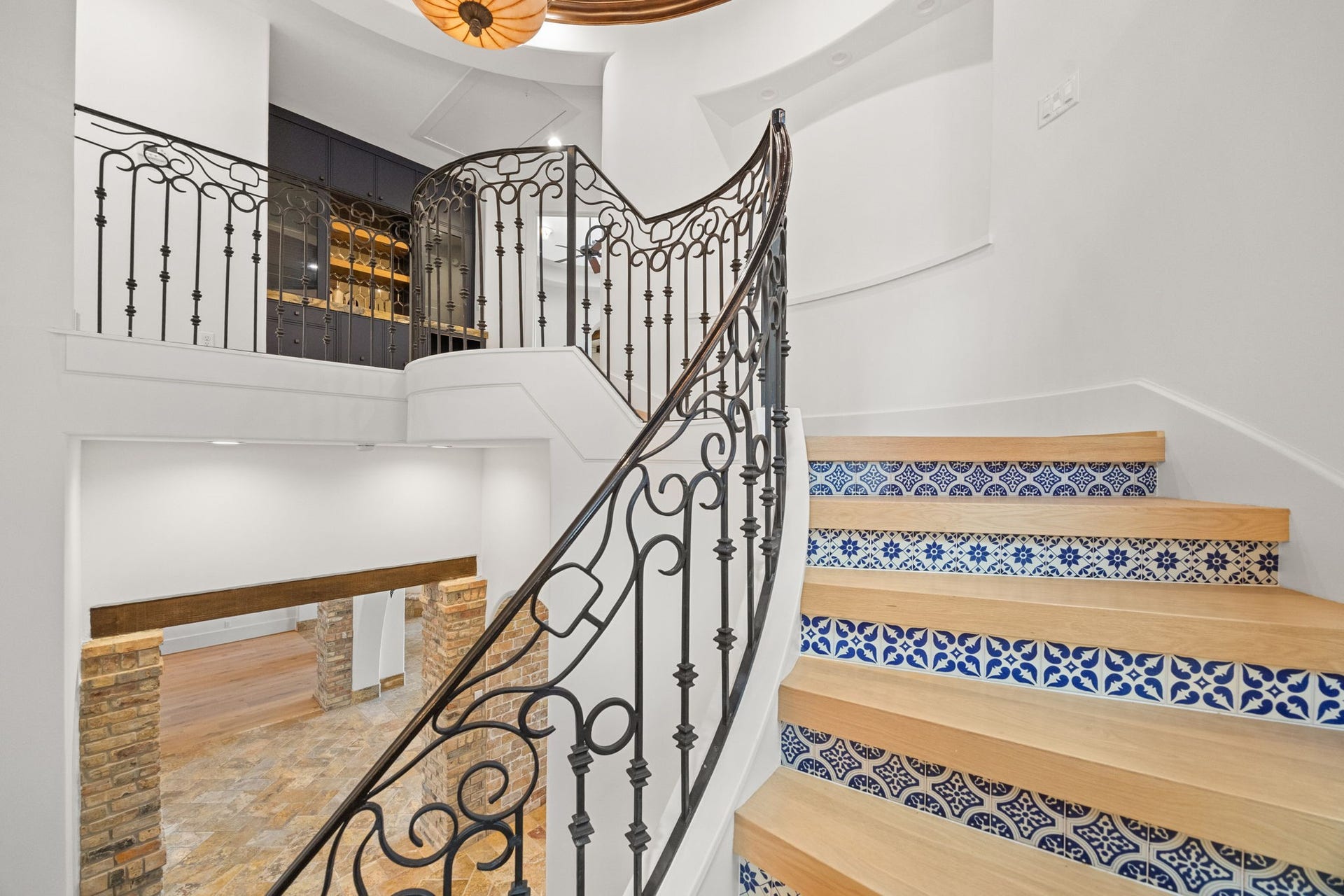 721 Harborside Way, League City, TX 77565 Another view of the grand staircase reveals its elegant ascent to the second level, where a stylish wet bar enhances the home's entertaining spaces.