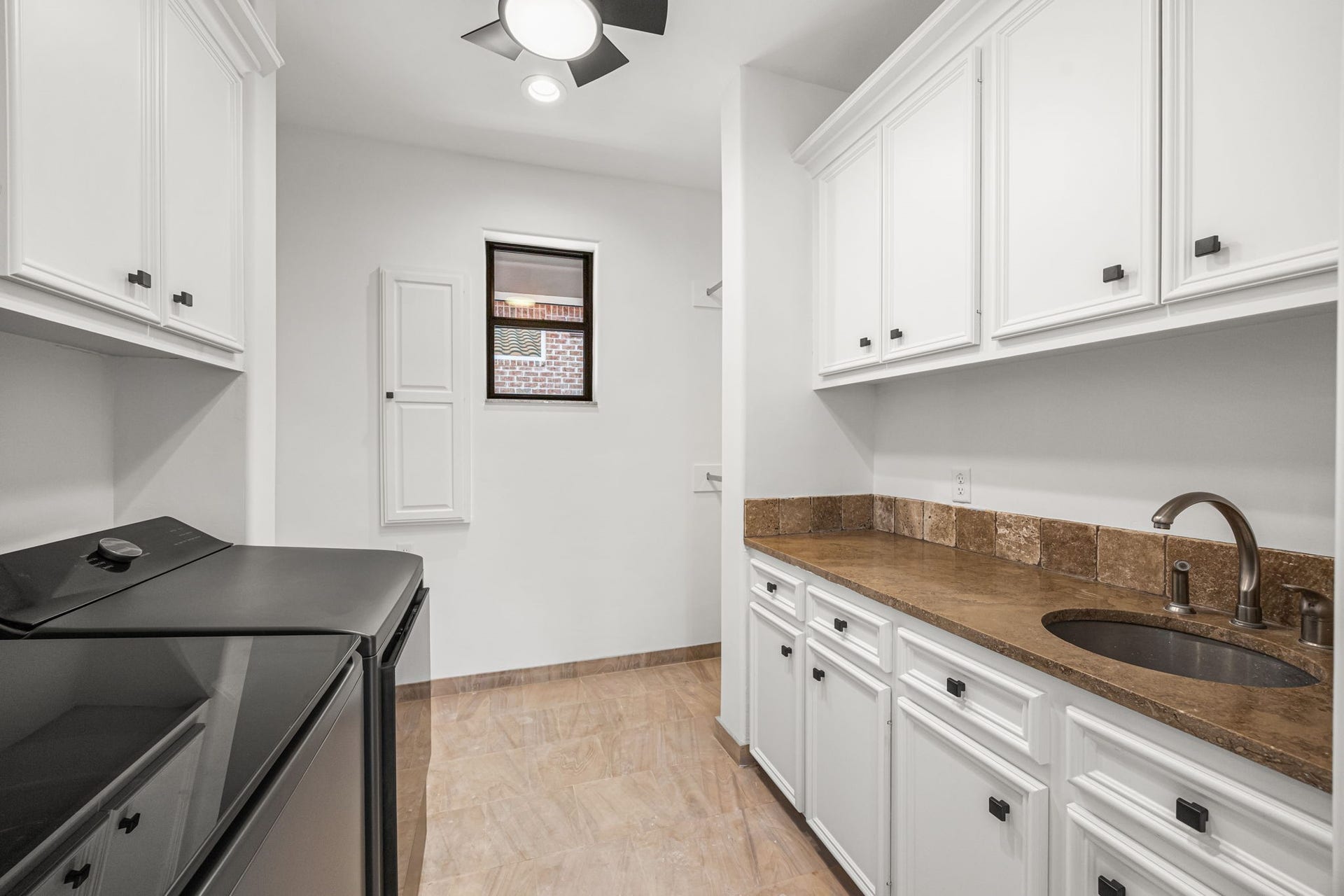 721 Harborside Way, League City, TX 77565 The upstairs laundry room is thoughtfully designed with custom cabinetry, clothing rods, and an extra-large closet for added convenience and storage.